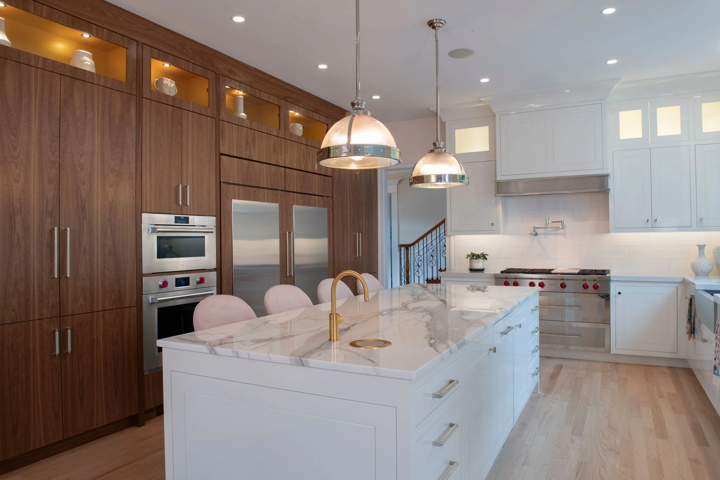 contemporary and bright kitchen with custom white and wood cabinets, white island, natural stone countertops, pendants, light boxes, gold zip drain, wolf range, double oven, coffee compartment, hidden microwave,  hardwood floors,  Interior design, in