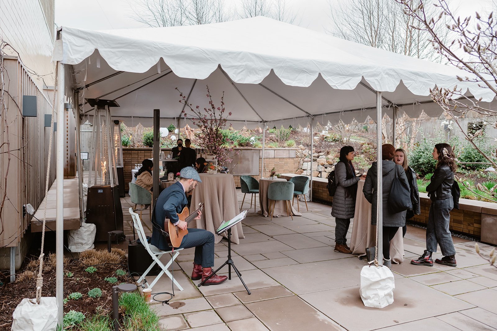  Party guests in outdoor, tented courtyard at Carroll Hall event venue in Brooklyn, NY  