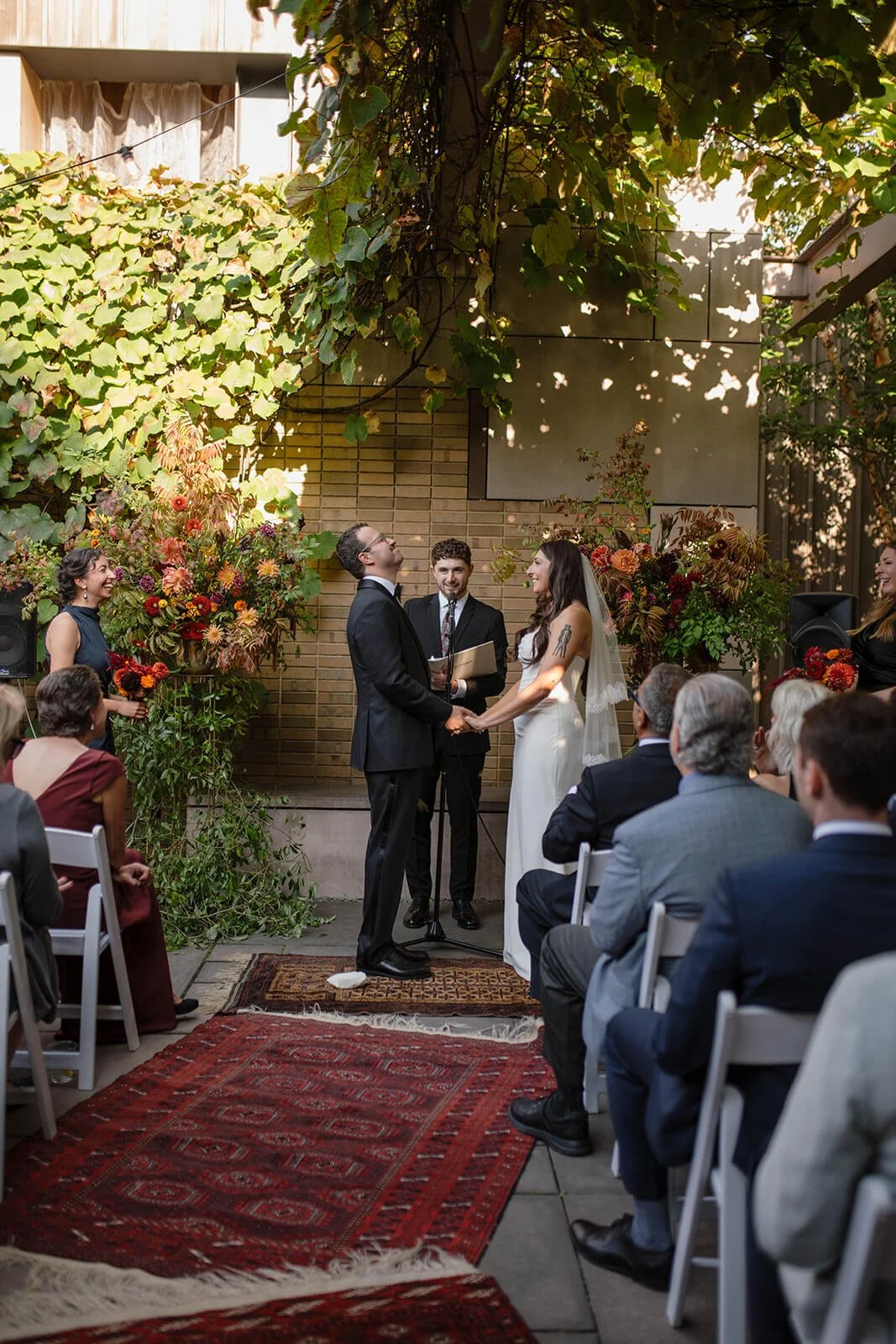 A couple saying their vows in a garden ceremony at Carroll Hall in Brooklyn, New York.