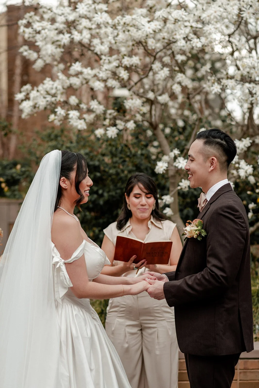 A couple saying their wedding vows in Carroll Hall garden