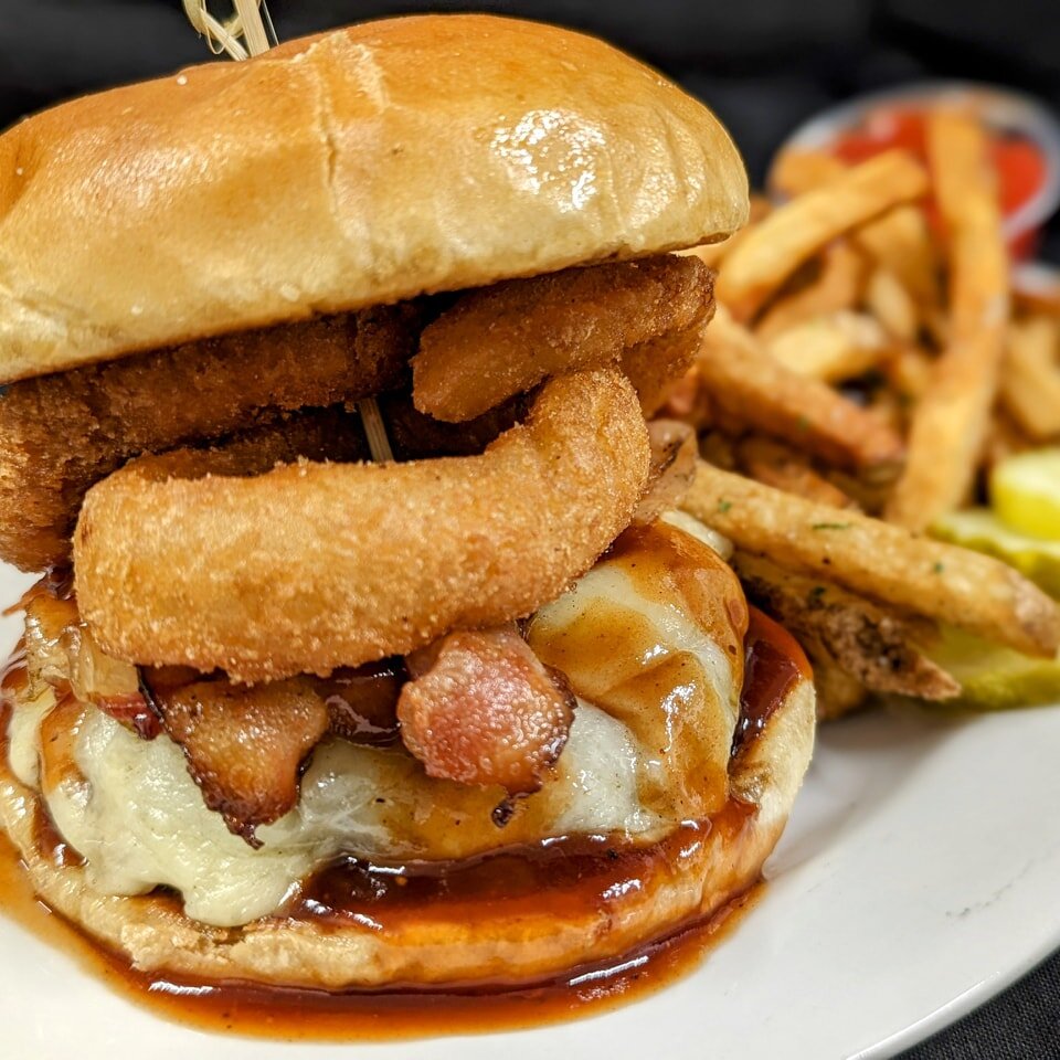 Hey hey hey! It's Monday and it's burger night at Moogs Place! All burgers are just $12! Tonight our featured burger is the classic rodeo burger topped with cheddar, bacon, bbq sauce &amp; an onion rings or two. It'll make you smile for sure! 
... Un