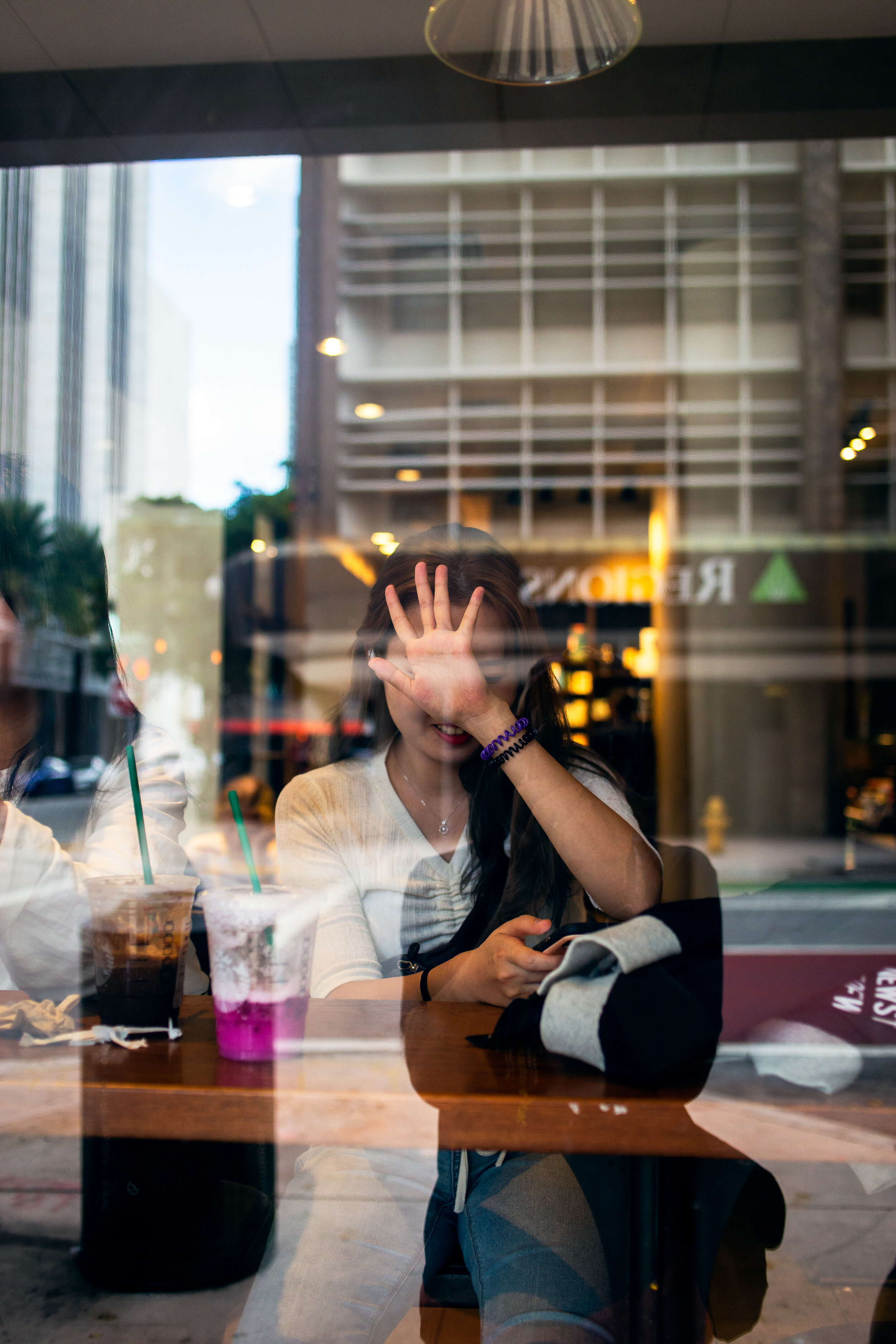 Girl blocking face Starbucks window-.jpg