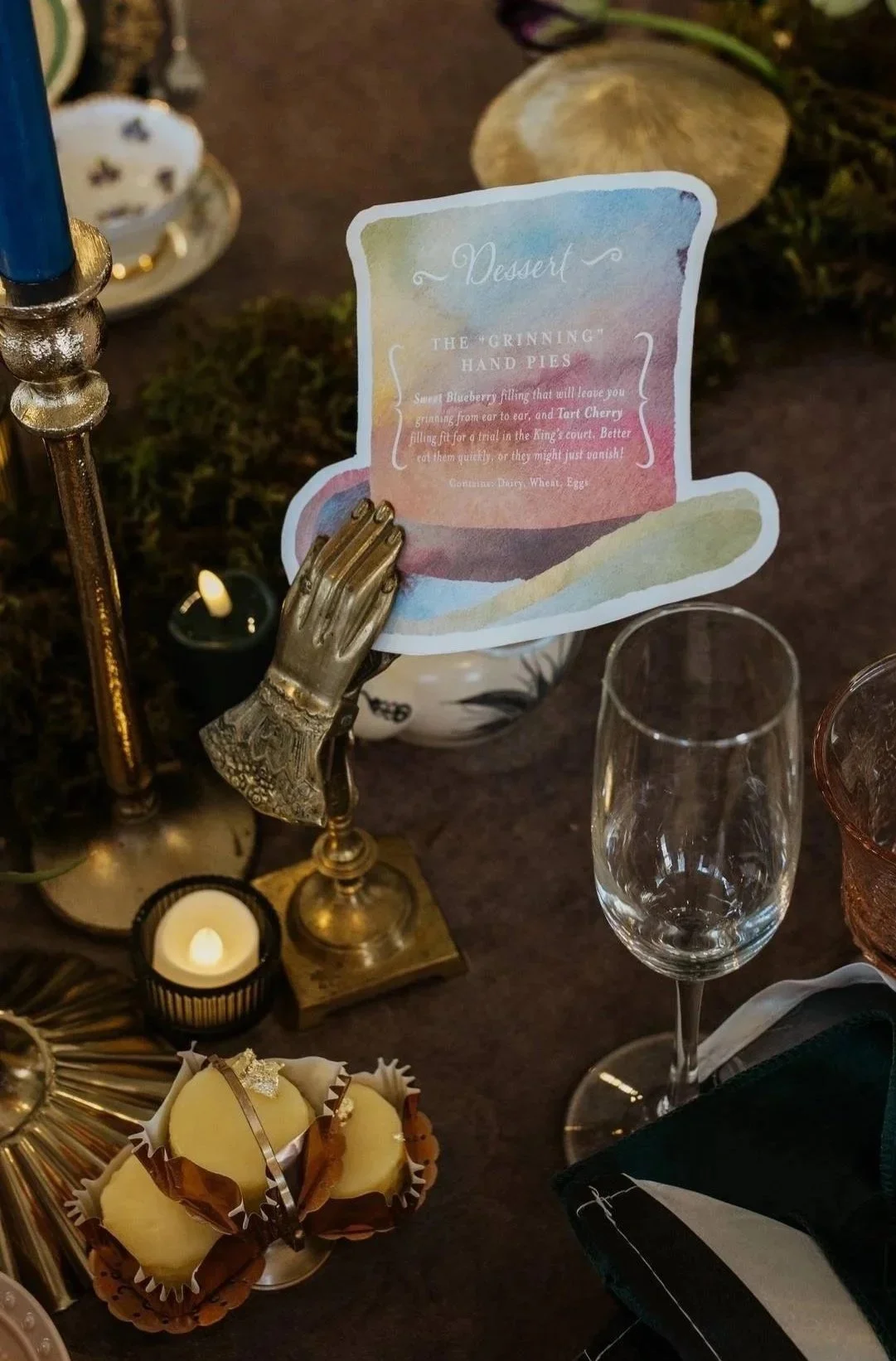 Dessert menu with custom watercolor art shaped into a top hat for a Mad Hatter’s Tea Party at an Alice in Wonderland themed wedding at the Victorian Belle Mansion in Portland, Oregon.