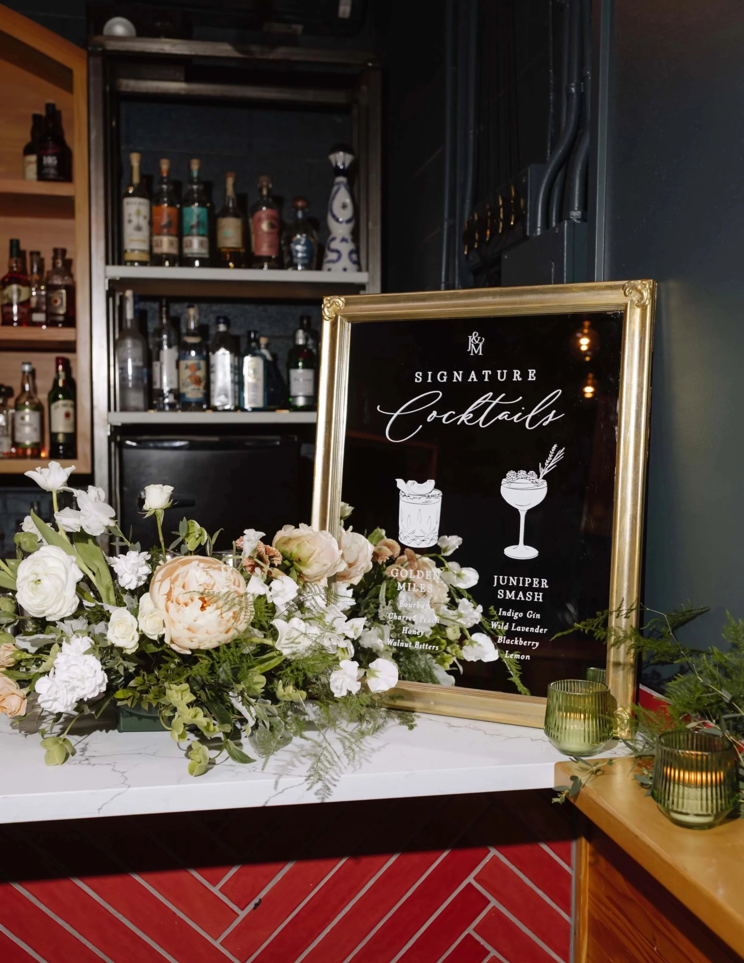 Cocktail menu bar sign on a mirror for wedding reception with illustrated icons of drinks and elegant cursive typography at the Ox Restaurant in Portland, Oregon