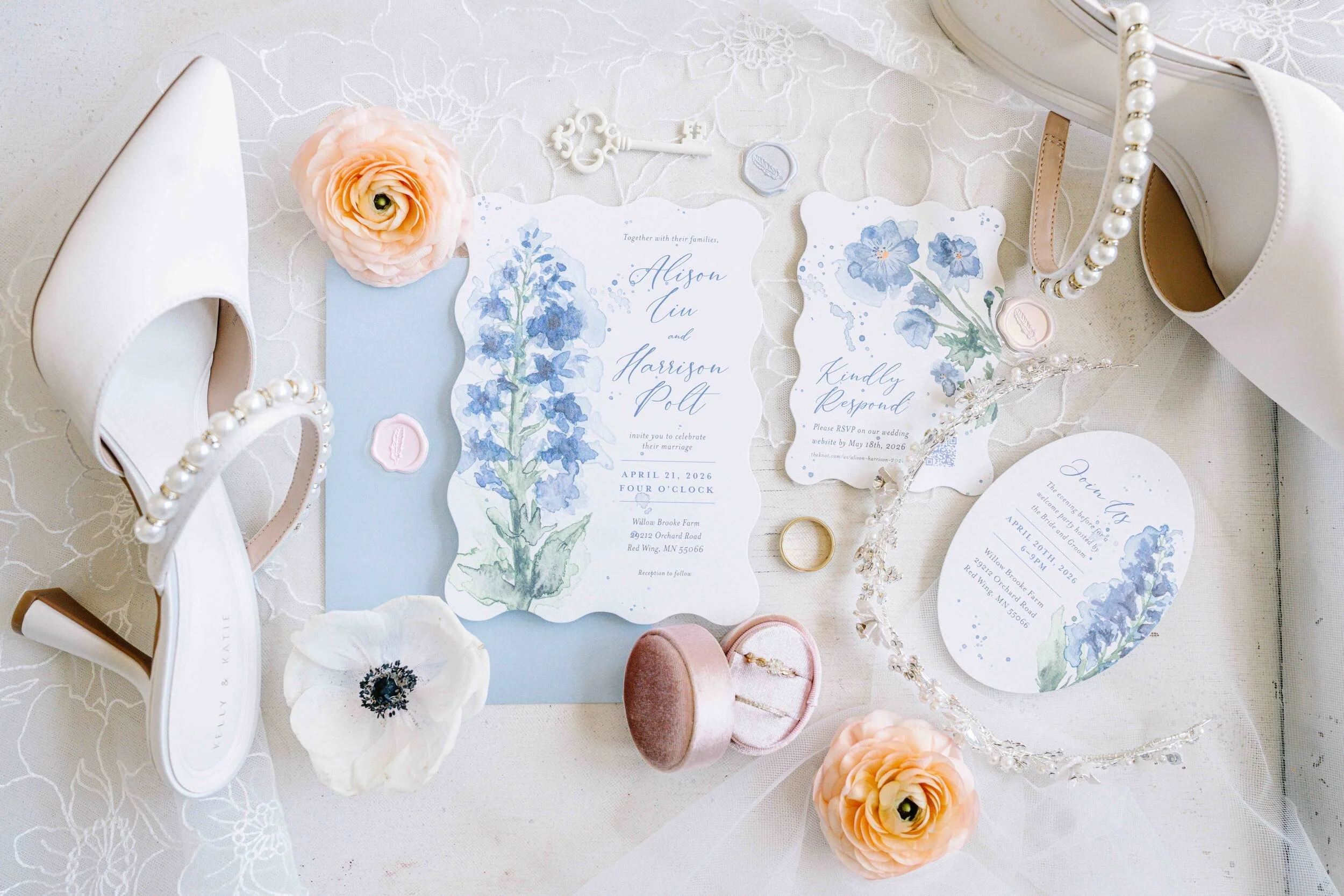 Wedding invitation suite flat lay with custom watercolor art of blue lobelia wildflowers with elegant calligraphy for the Willowbrooke Farms wedding venue in Minnesota