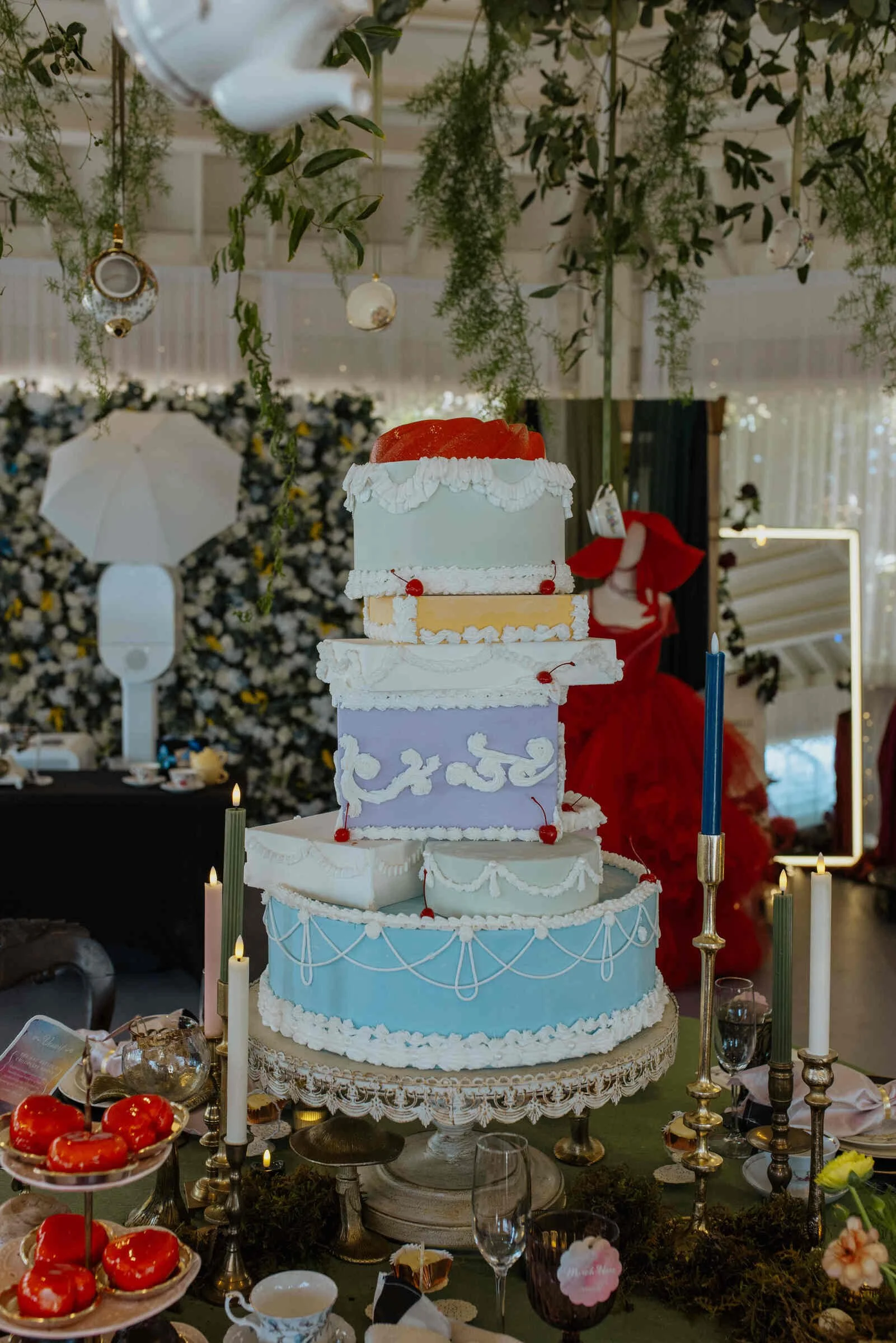 Alice in Wonderland tea party themed wedding tables cape with candlesticks, decor and topsy turvy cake