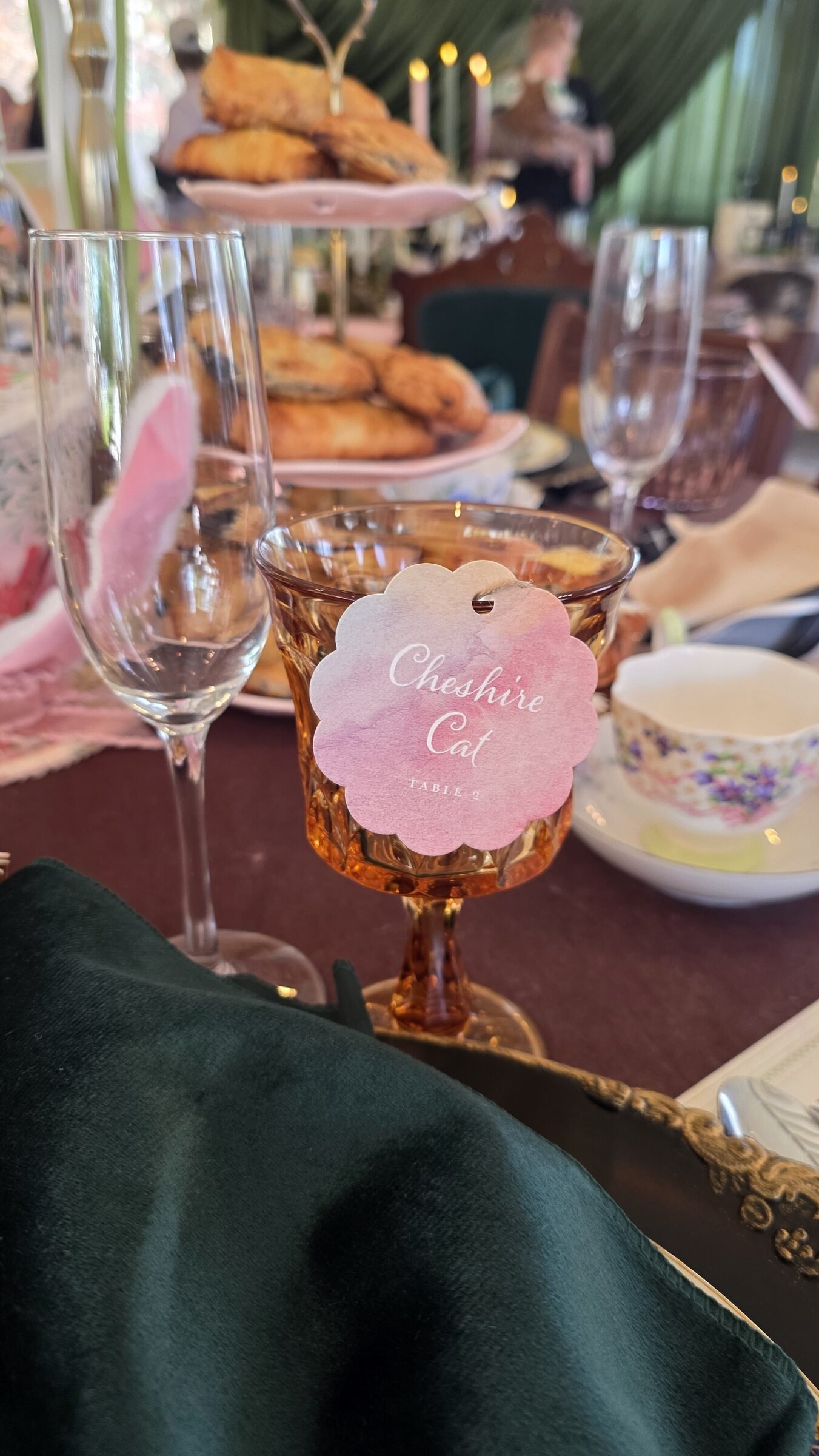 Alice in Wonderland wedding theme tea party table setting colorful watercolor name card tied with an ornate brass key