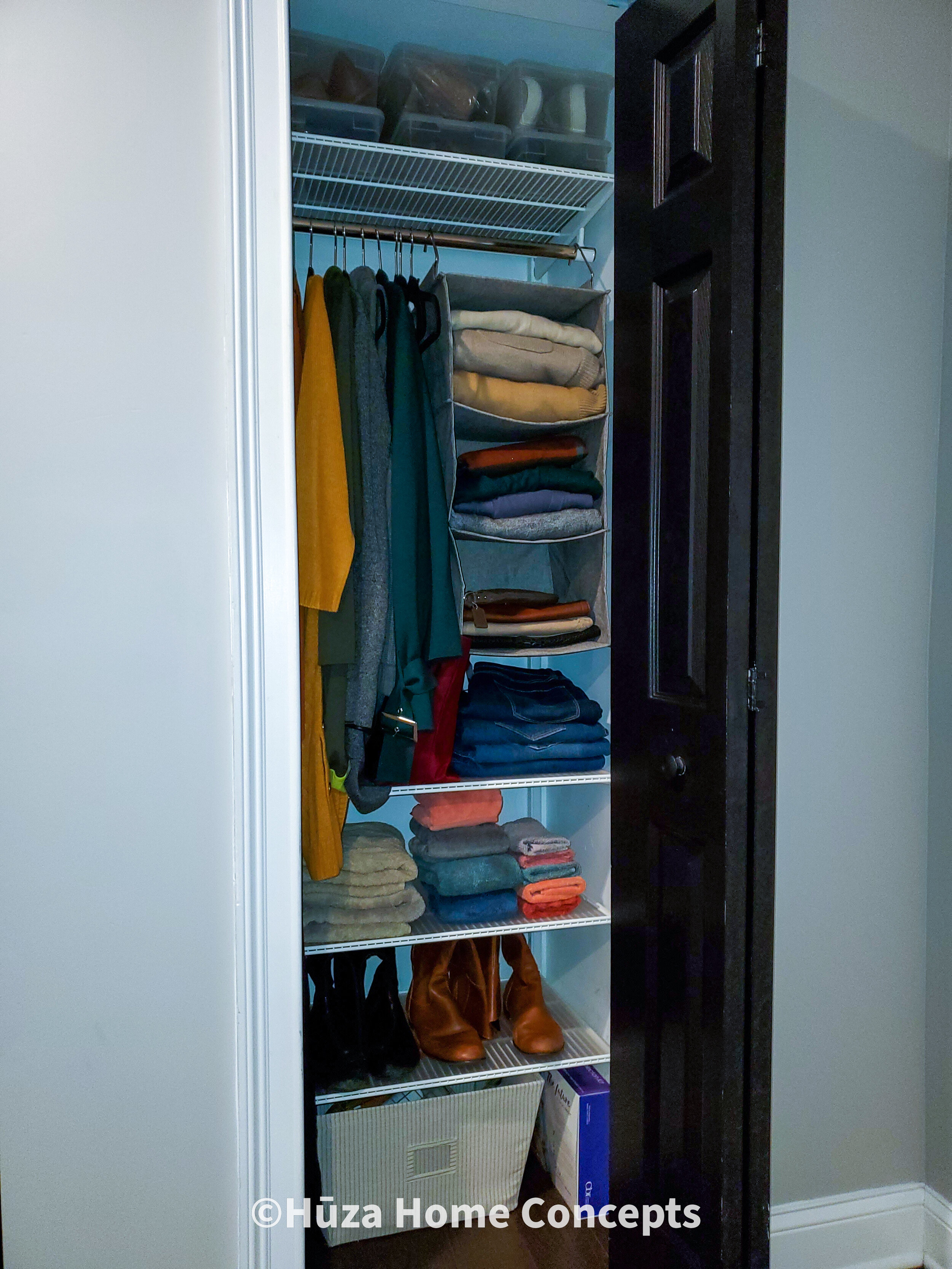 Smaller Closet (after): Containers above, hanging shelving, and bins at the bottom ensure no space is wasted in this compact closet space.
