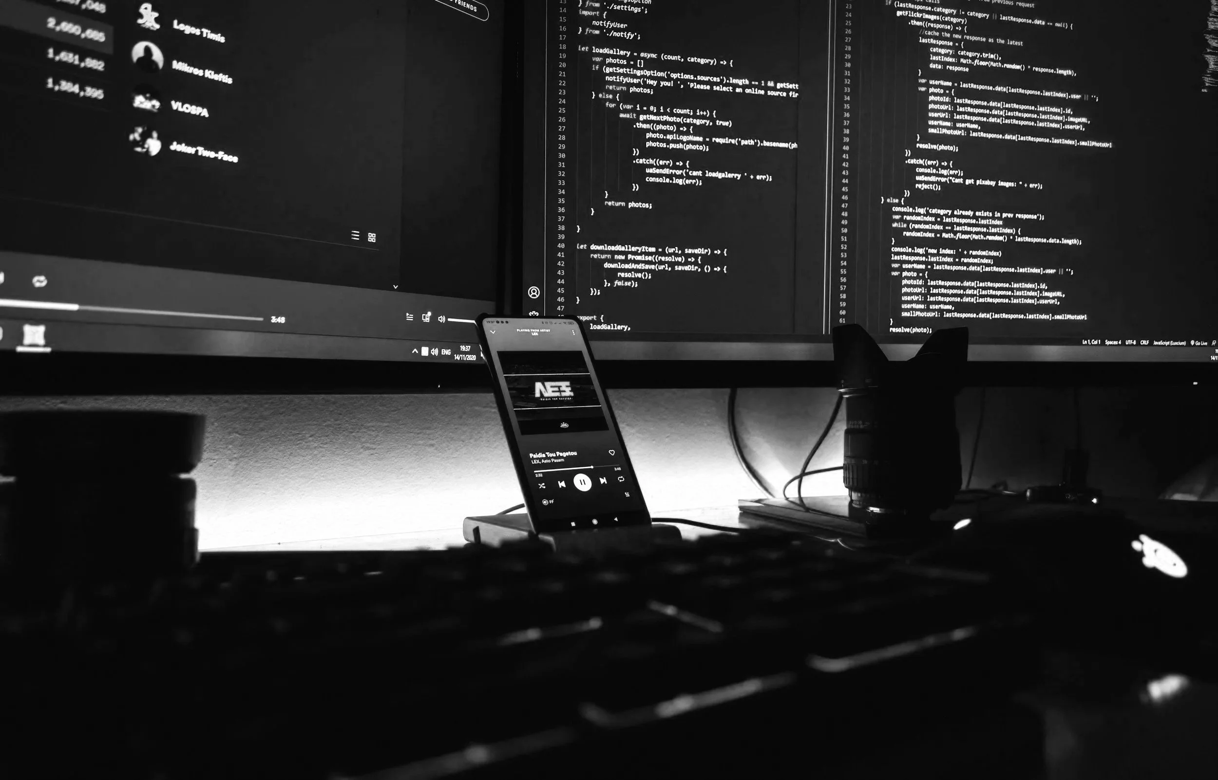 Desk with three monitors and a phone on display