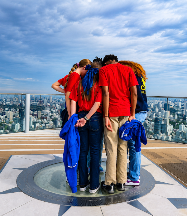 a group of students at Shibuya Sky participating in a teamwork exercise
