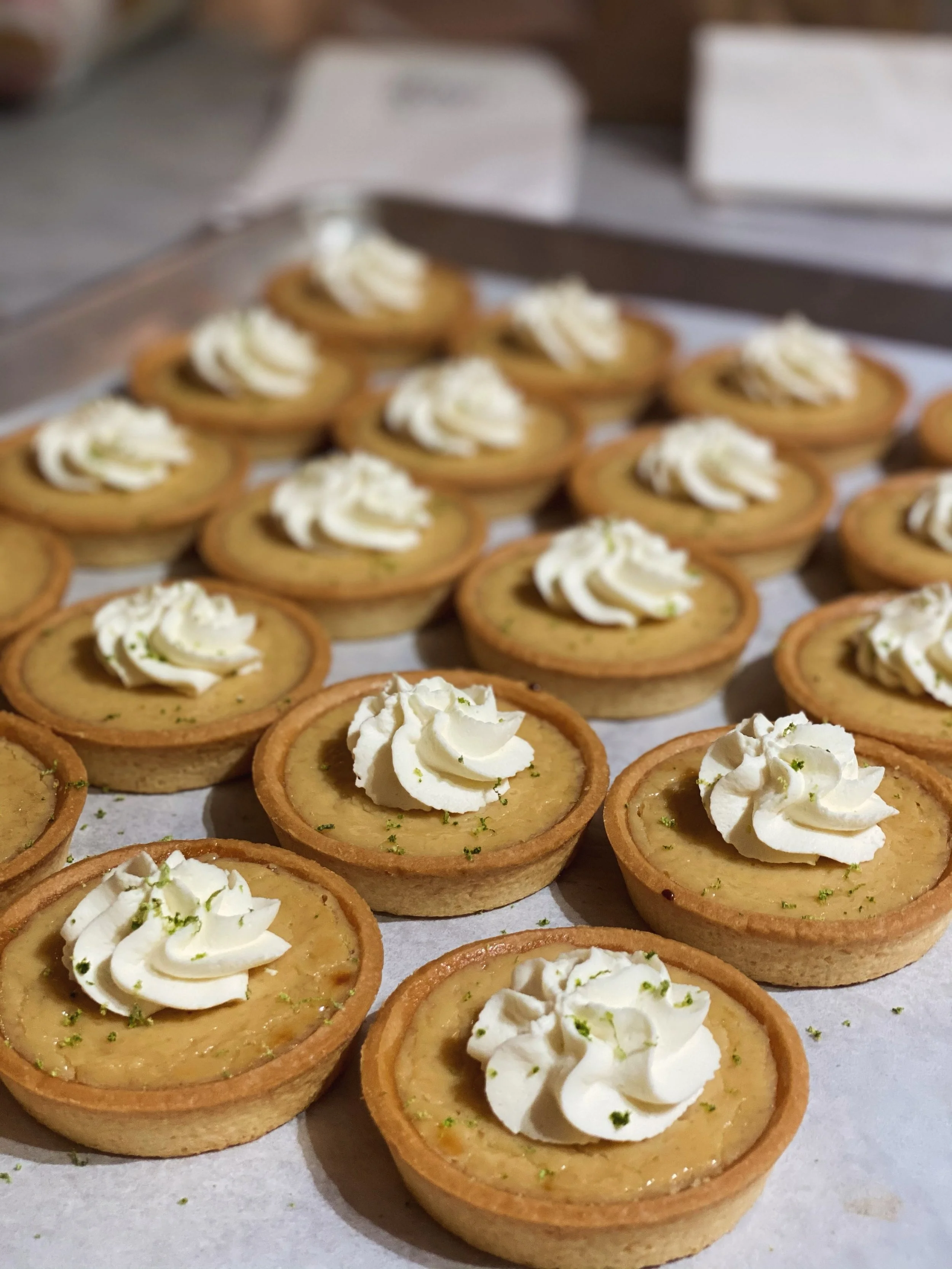 🍋&zwj;🟩 A little taste of sunshine! Our petite key lime tarts are topped with fluffy whipped cream and a fresh sprinkle of lime zest for the perfect sweet treat.

Our bakery is always busy whipping up delicious desserts and pastries, so stop by our