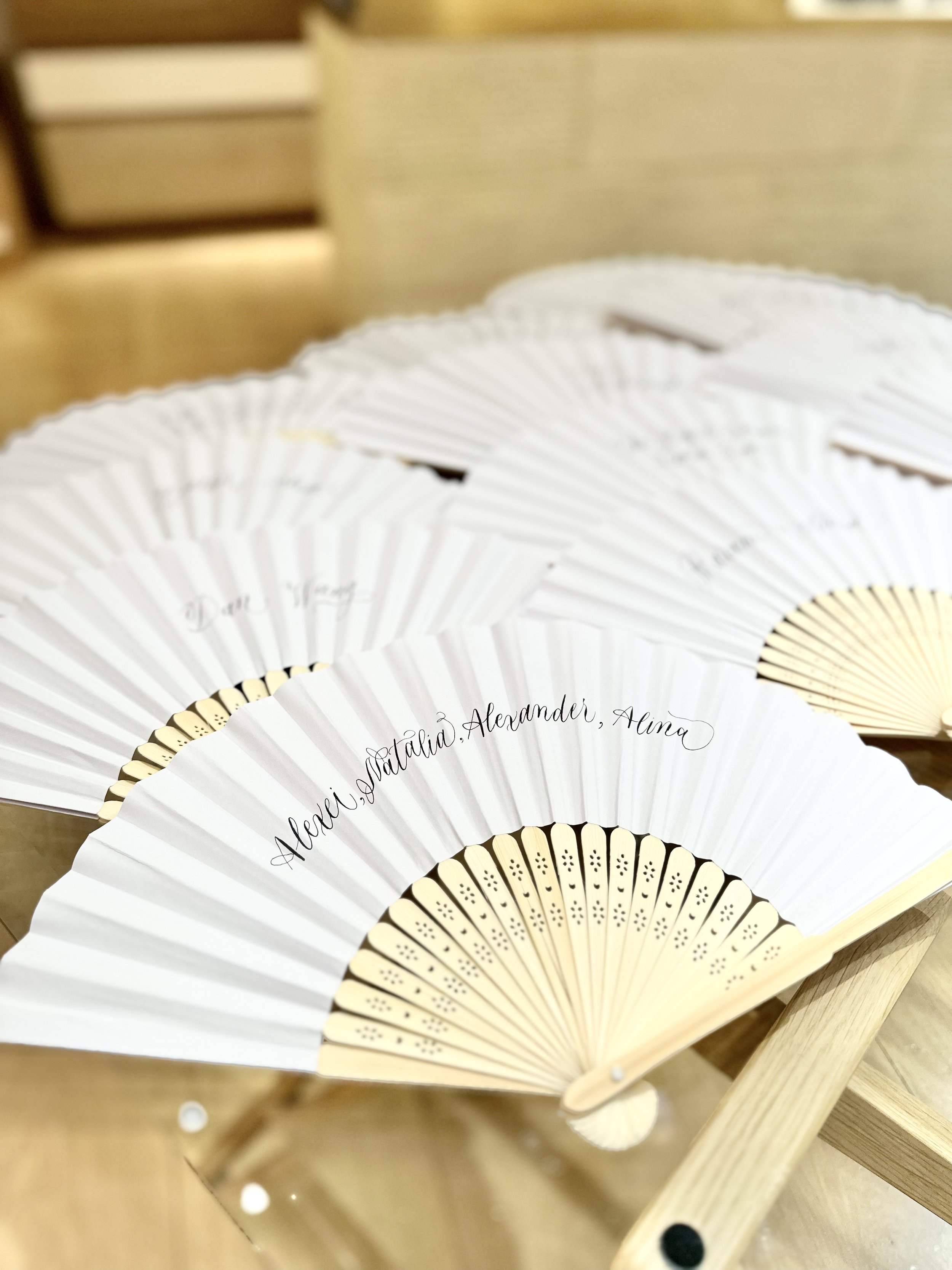On site calligraphy on hand fans by Orlando's best calligrapher a handful of letters
