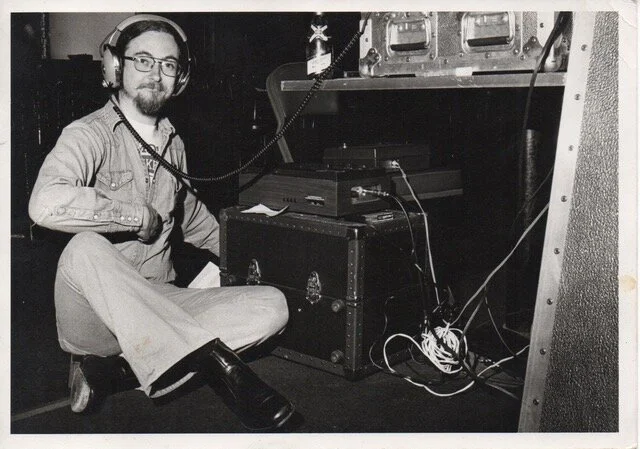 Lee Brenkman “Dubbing tapes”. Soundcraft 1s console in its integral aluminum road case and an Advent 201 cassette machine.