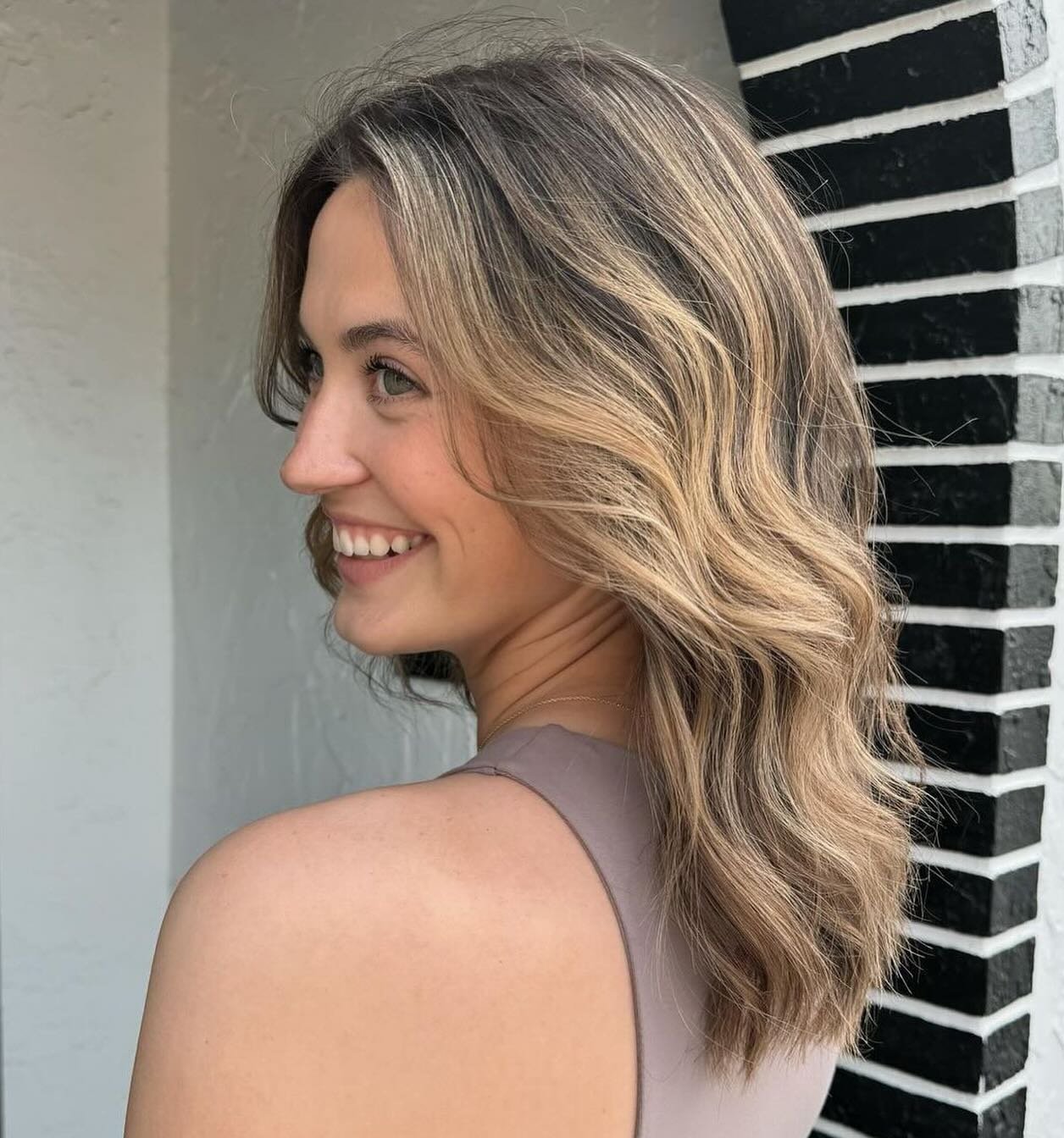 We may be bias, but we feel like that smile is because of her fresh bronde balayage. Brunette girls can be brighter for the summer with low maintenance. Just choose one of our blonding packages and we will completely customize it for you. 

Stylist: 