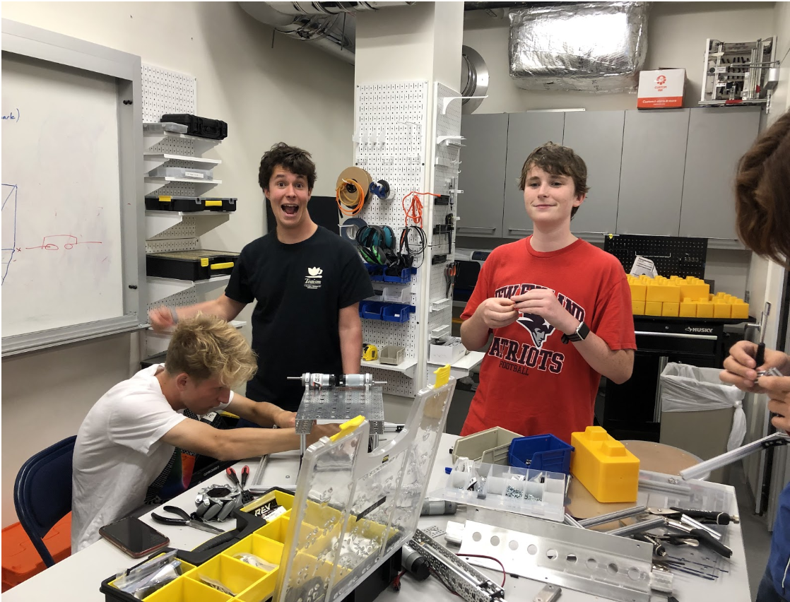 Ethan Lior '20, Zach Rothwell '20, Matt Olins '23, and Henry Chang '23 working on the robot.