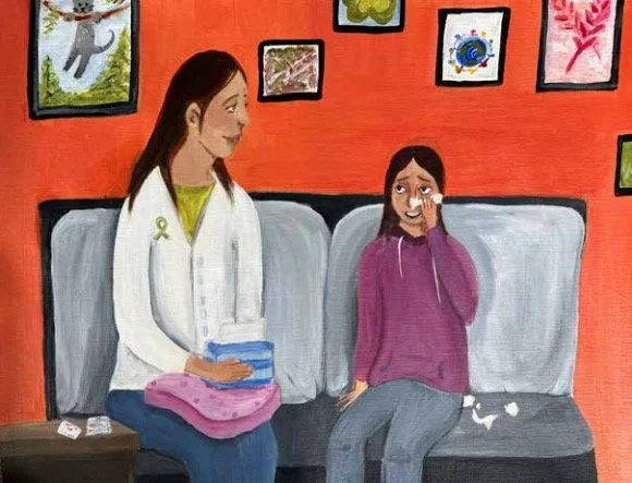 An adult comforts a crying youth on a couch, with colorful art on the wall behind them, symbolizing a supportive space for mental health conversations.