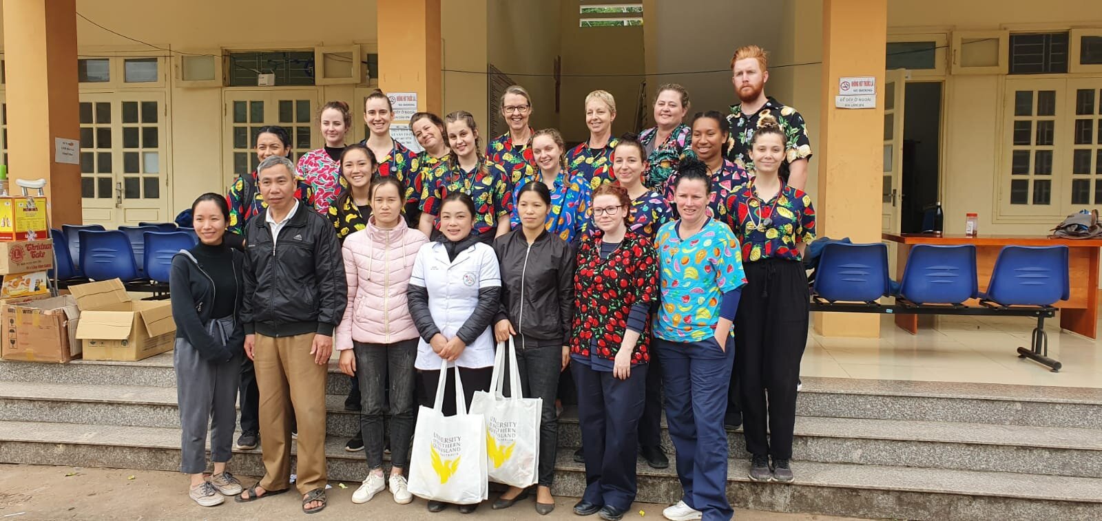 student nurses having fun while meeting local health workers in vietnam.jpg