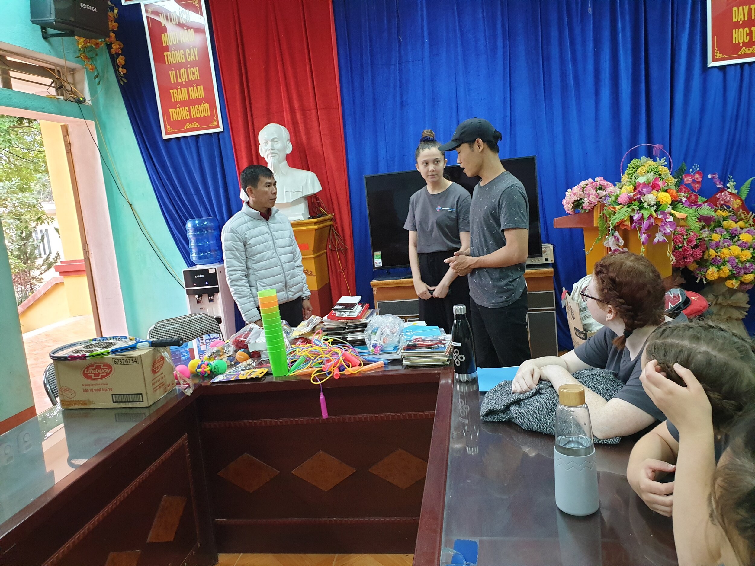 students and local health workers with donations in vietnam.jpg