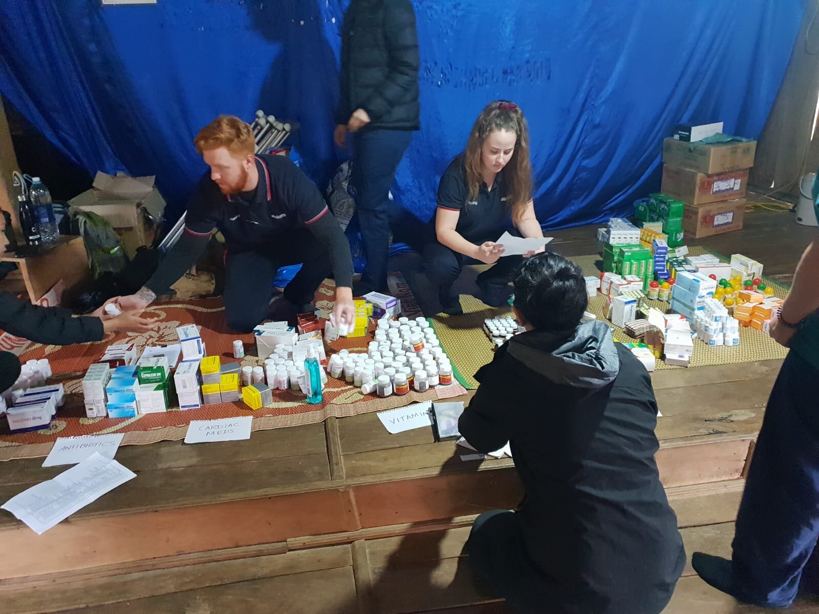 students stocktake pharmaceutical donations for mobile clinic.jpeg