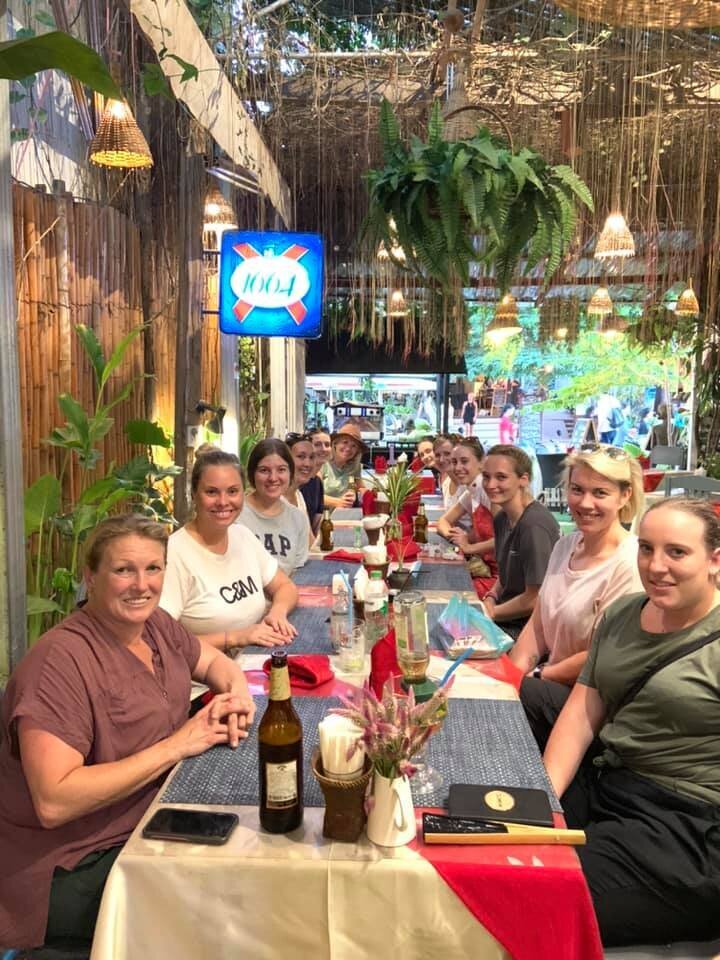 students enjoy a group meal while on placement in laos.jpg