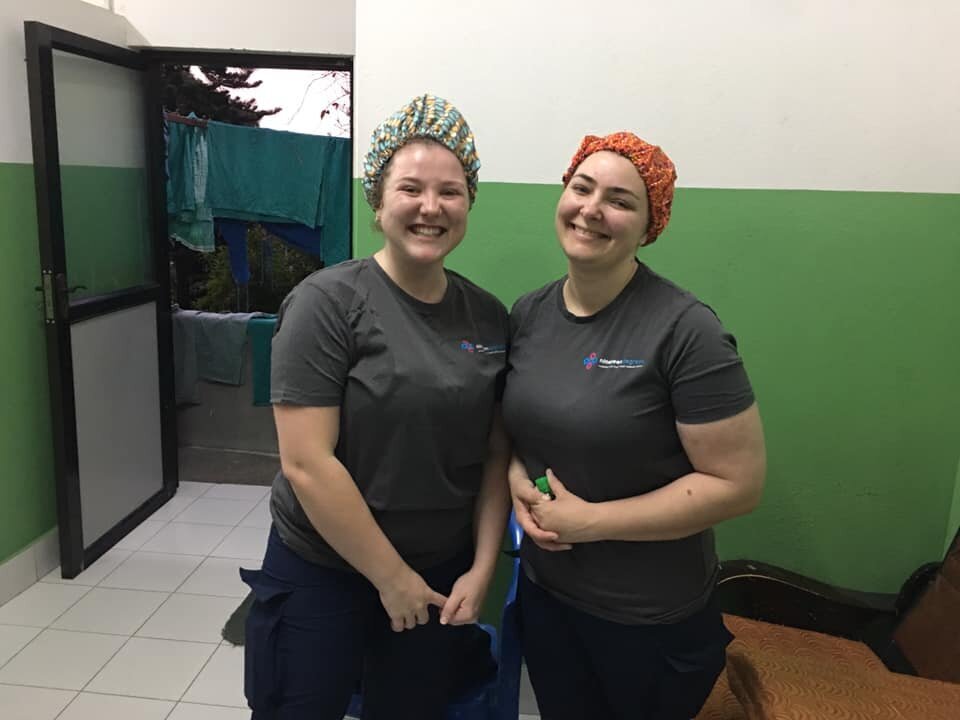 nursing students gown up for surgery in nepal.jpg