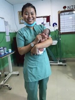 nursing student and newborn baby at hospital in nepal.jpeg