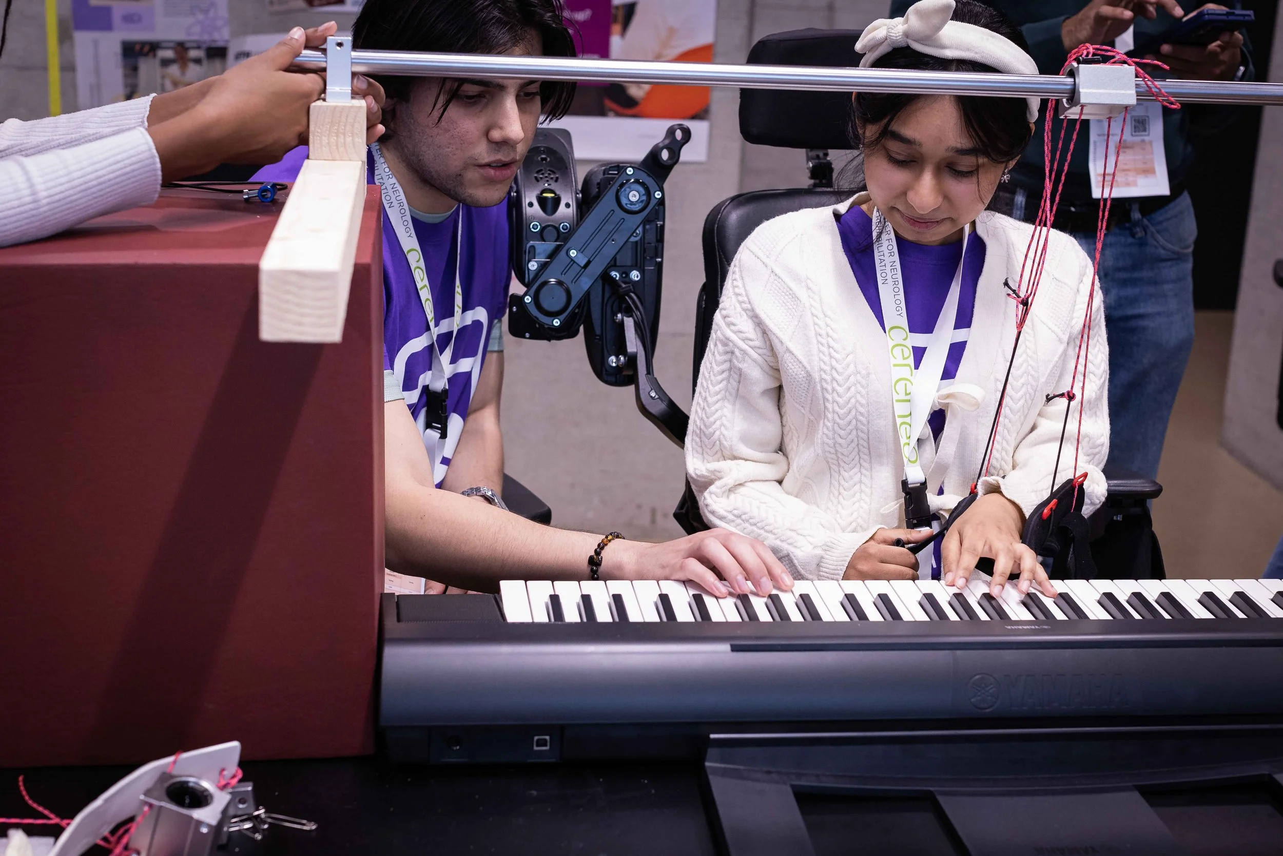 Two people sitting on a keyboard with a prototype.