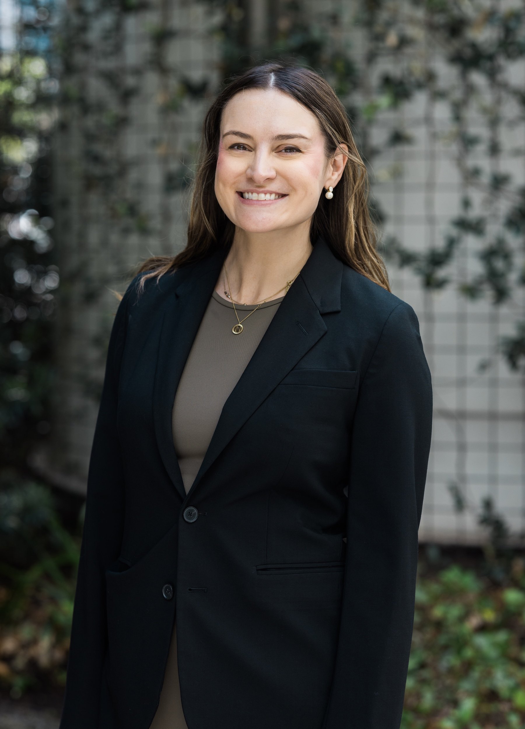 Associate Nicole Hager Fingeroot standing outside energy litigation firm Hogan Thompson Schuelke's downtown Houston offices.