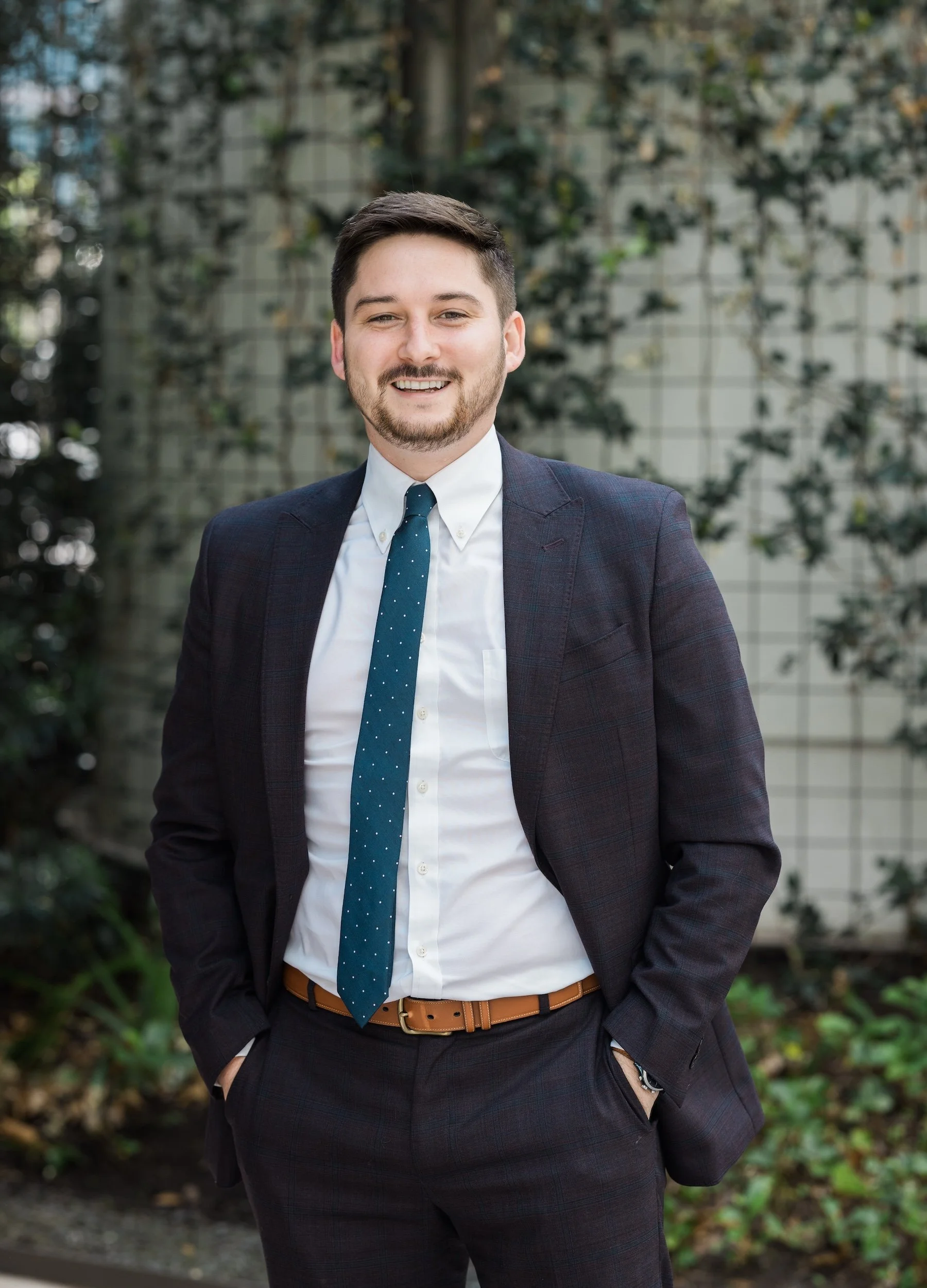 Associate Hayden Hawkins standing outside Hogan Thompson Schuelke's law firm offices in downtown Houston at 1001 Fannin.