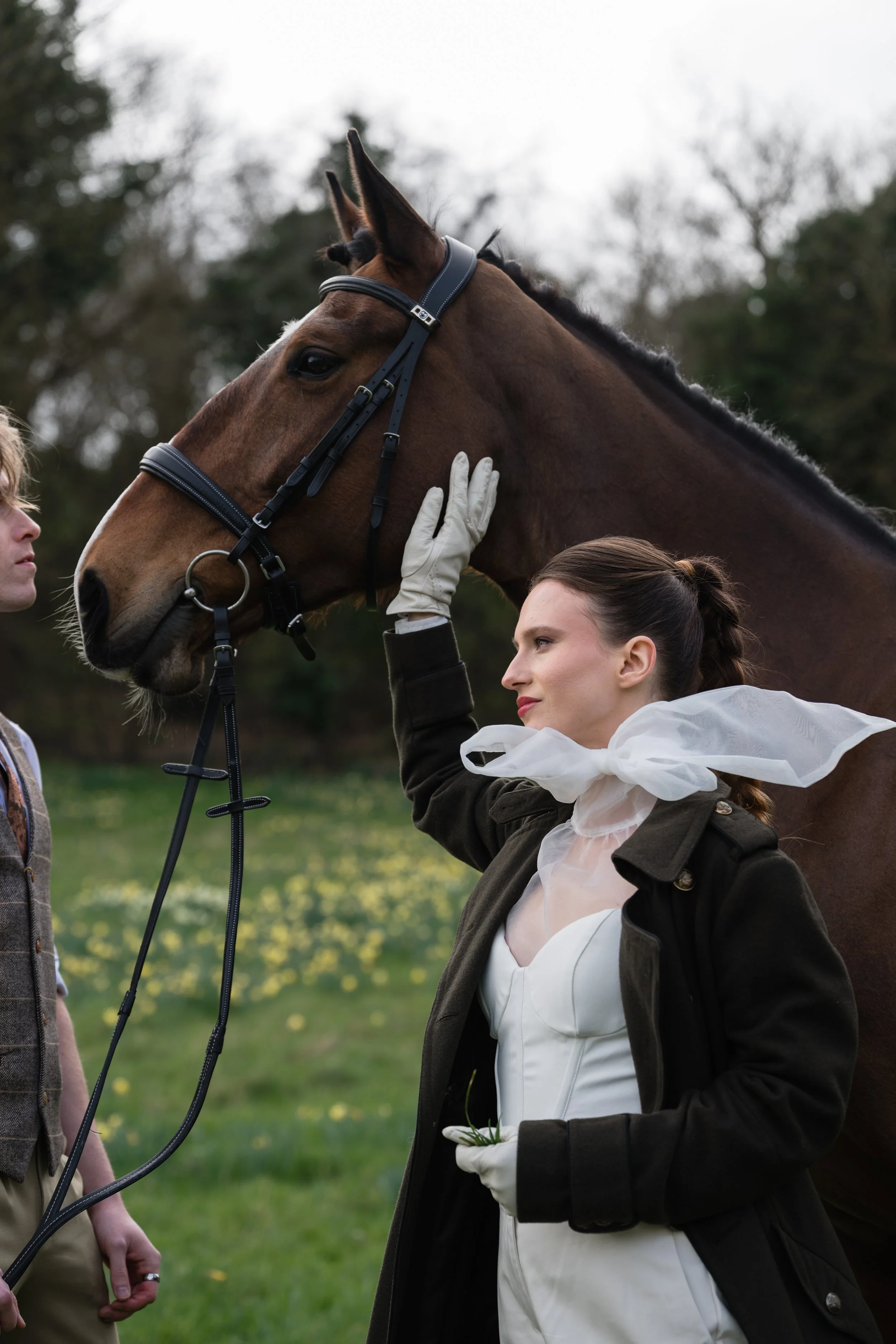 bride and groom with a horse standing 
