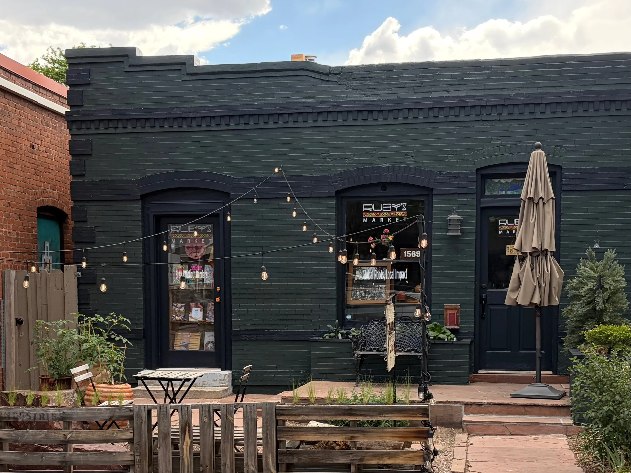 The front of Ruby's Market, painted dark green with black trim in June 2026