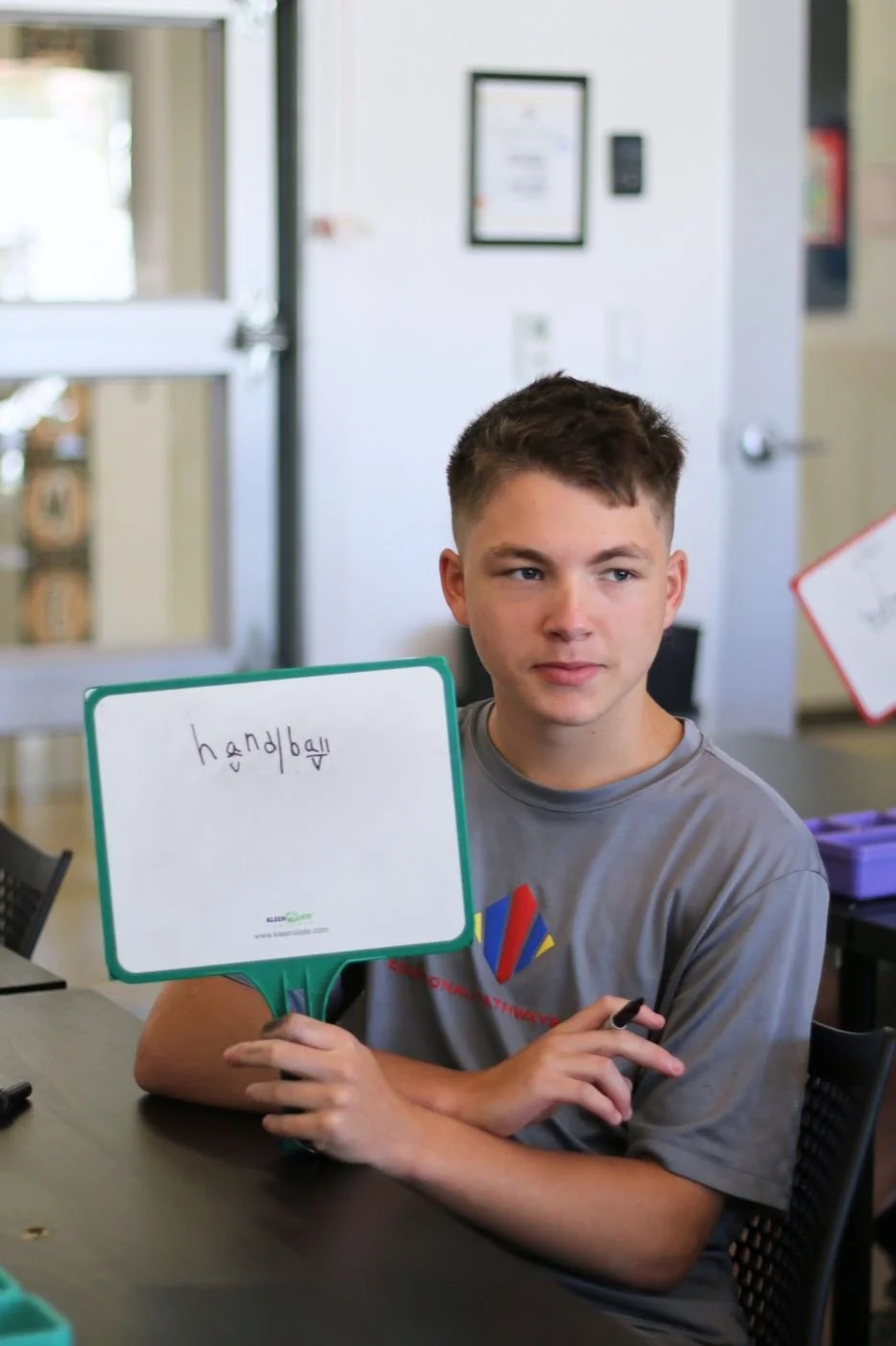 Student with learning differences engages in syllabication lesson in Orton-Gillingham class at Educational Pathways Academy, a private school for dyslexia and learning disabilities in Florida.jpg