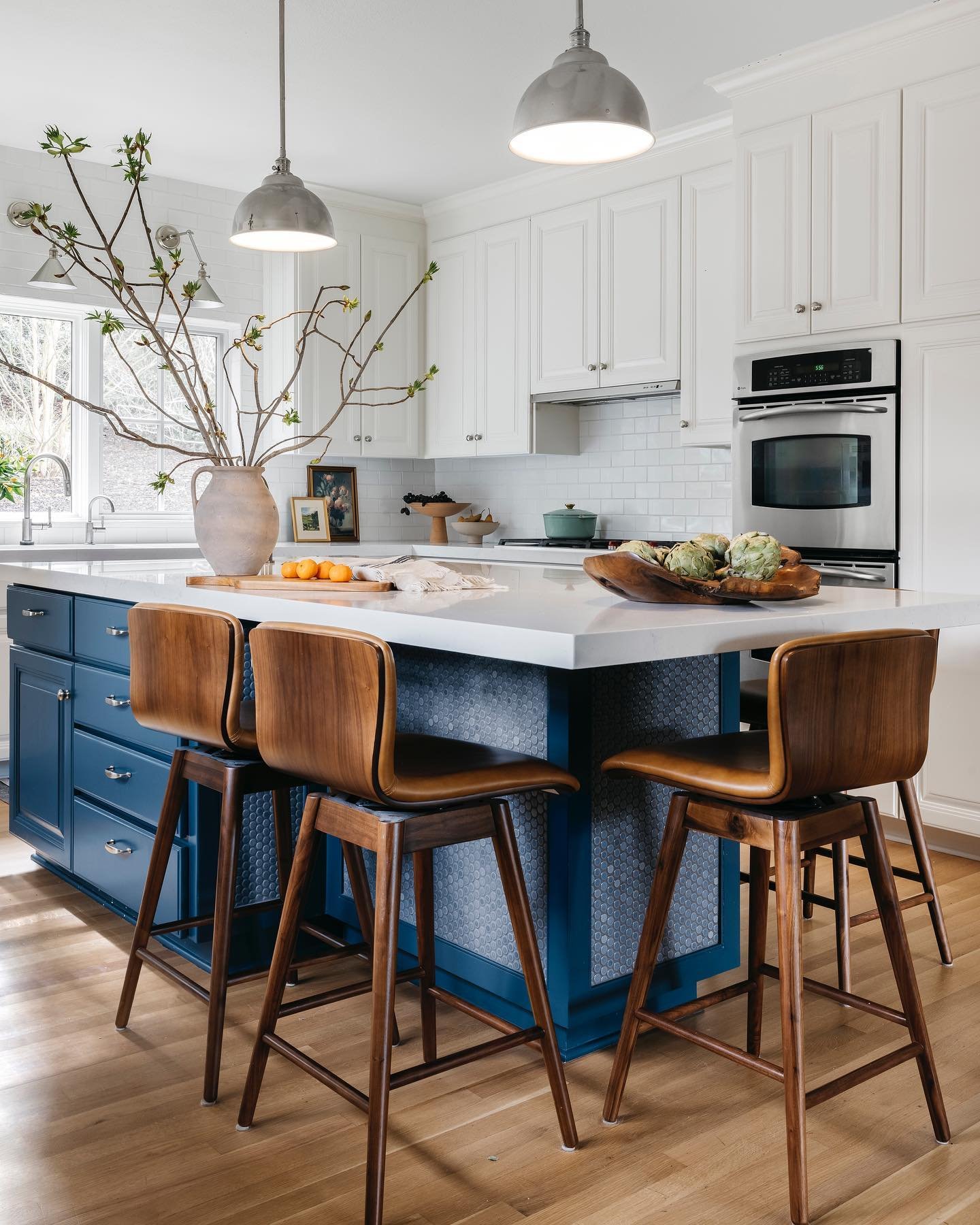 Sometimes a gut remodel isn&rsquo;t what you need for a kitchen refresh. In this kitchen, we kept the footprint and original cabinetry intact, and simply added a modern coat of paint, some new countertops and backsplash, and a fresh island with exten