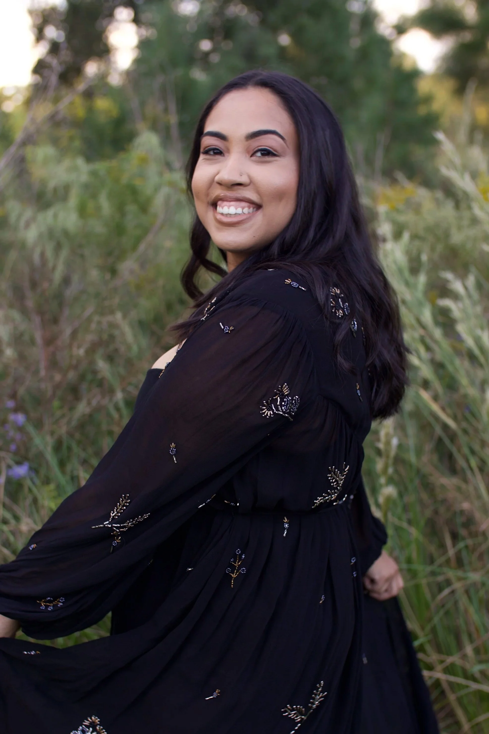 Newborn care specialist and doula in San Diego, California smiling outdoors, offering gentle newborn sleep conditioning and postpartum support