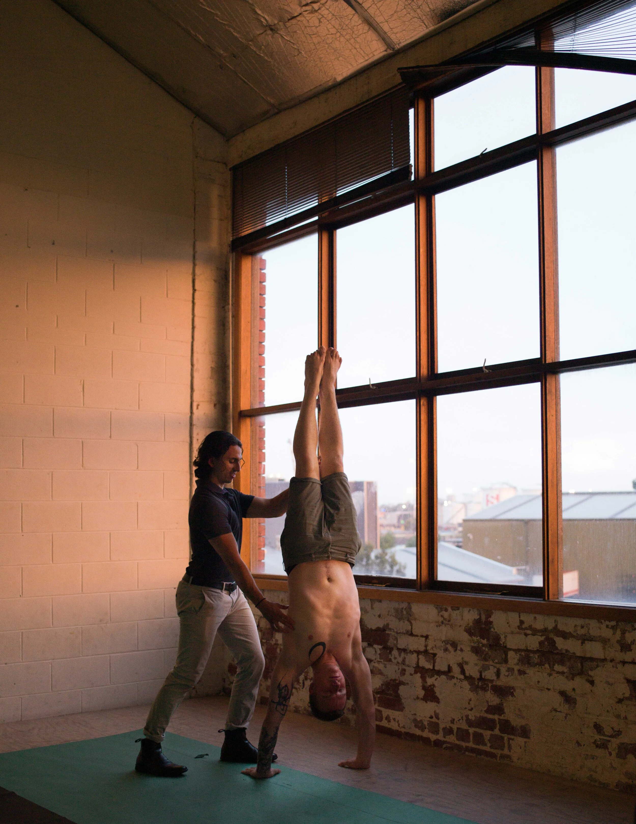 Jesse David Soopaya providing physiotherapy in Collingwood at Lionheart Integrative Therapies, assessing posture, breathing, and movement control.