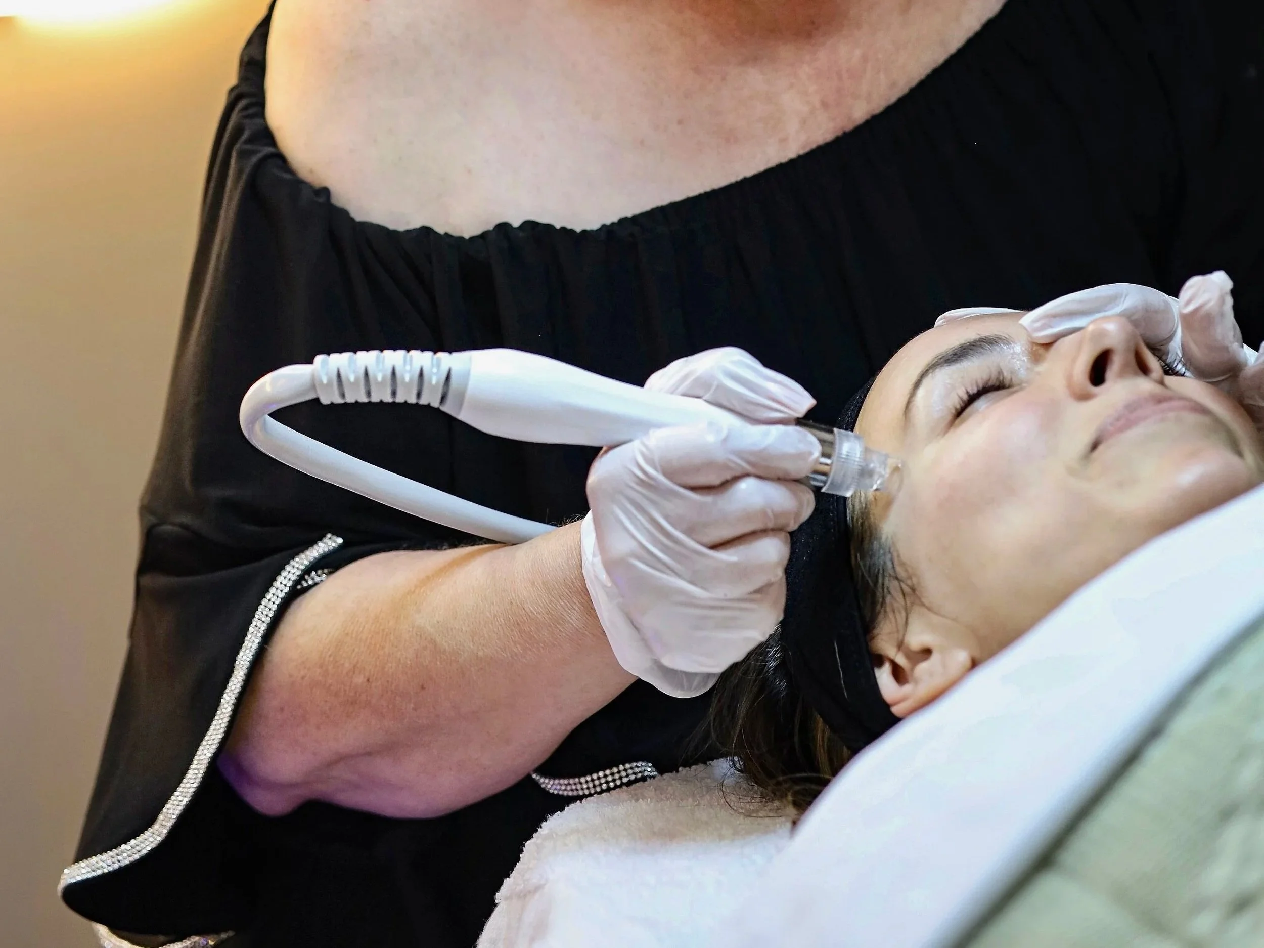 Esthetician performing hydrofacial