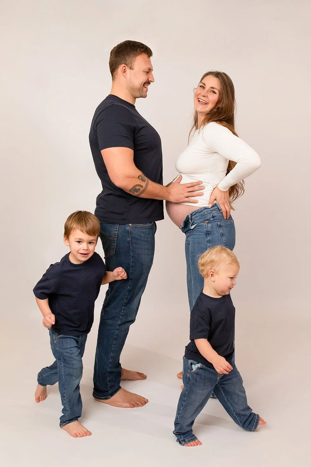 expecting parents and two boys during a relaxed maternity photoshoot in Cheltenham The Cotswolds