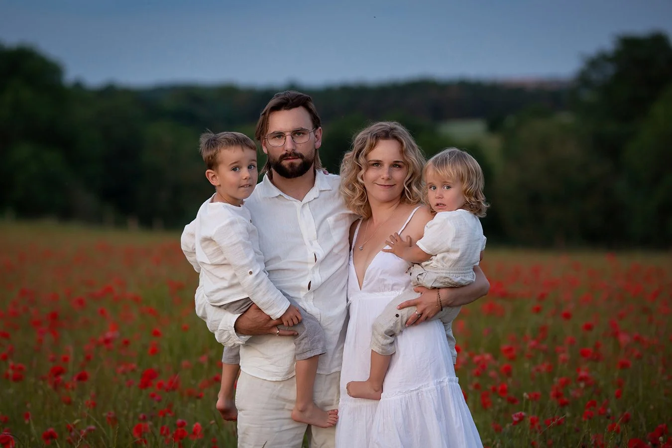 mum dad holding two boys during a portrait photoshoot in Cheltenham Gloucestershire