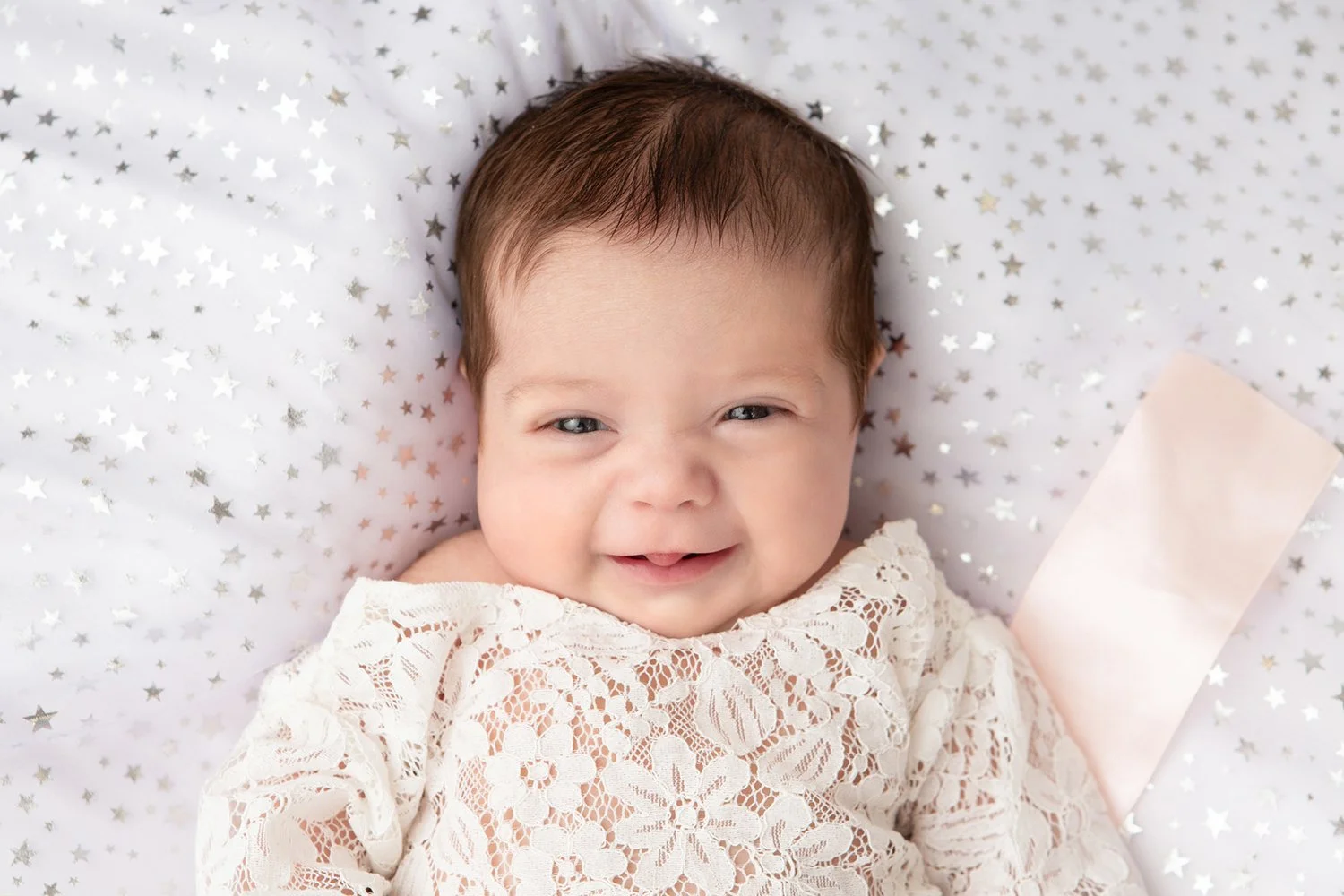 baby smiling during newborn photoshoot in Cheltenham
