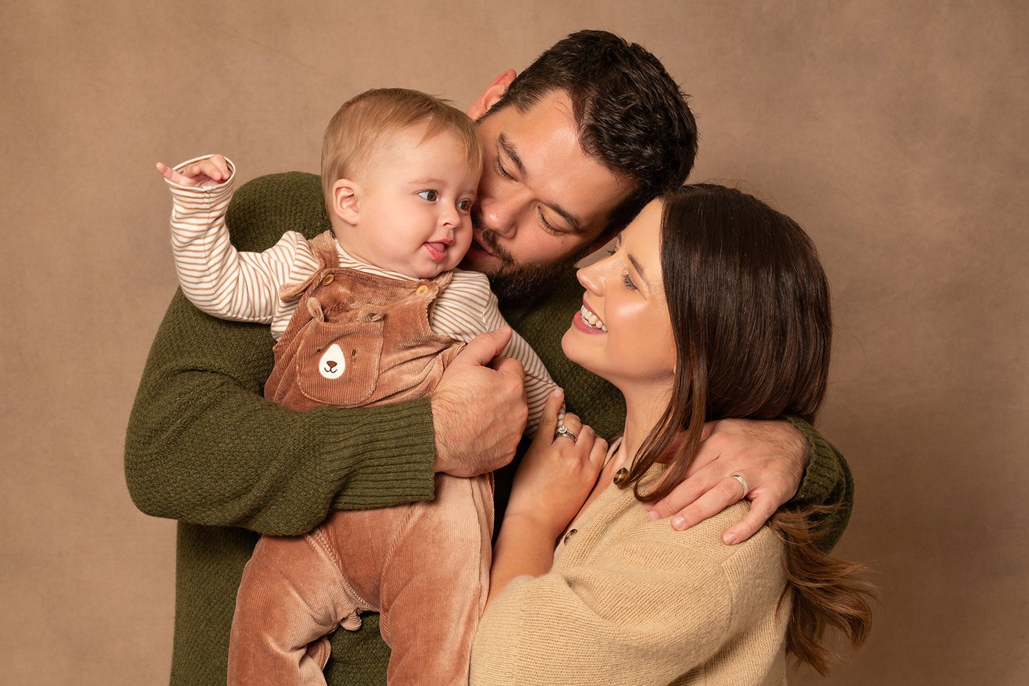 photo of baby boy with mum and dad during family photoshoot in Cheltenham Gloucestershire