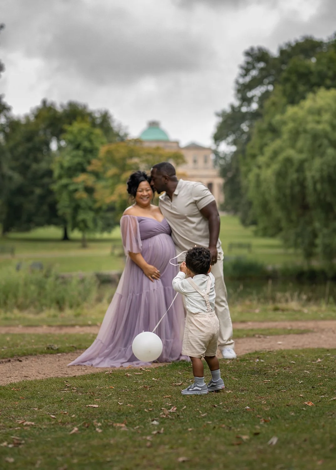 pregnant parents and their toddler in Pittville Park in Cheltenham during a maternity and family photoshoot