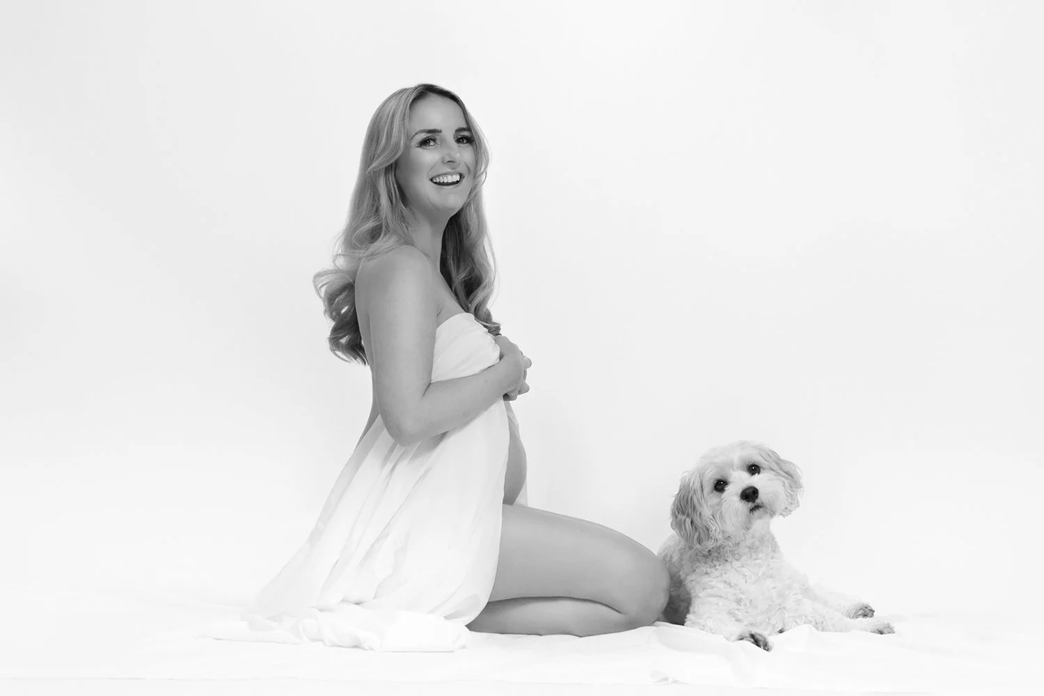 a pregnant woman and her dog during a studio maternity photoshoot in Cheltenham
