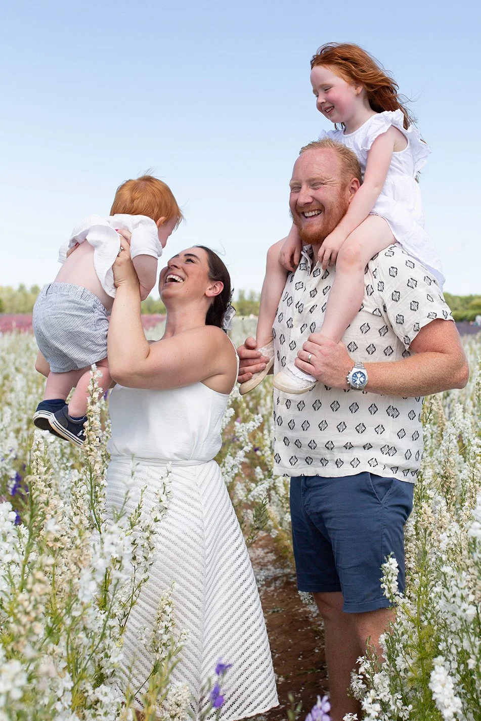 family having fun at the confetti flower field during the family photoshoot