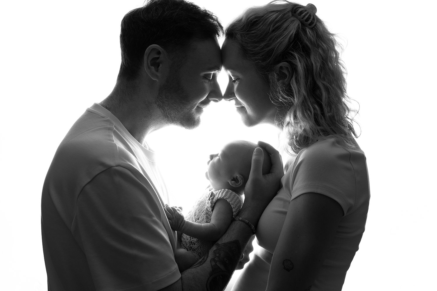 new parents holding a newborn baby during a family photoshoot in Cheltenham Gloucestershire