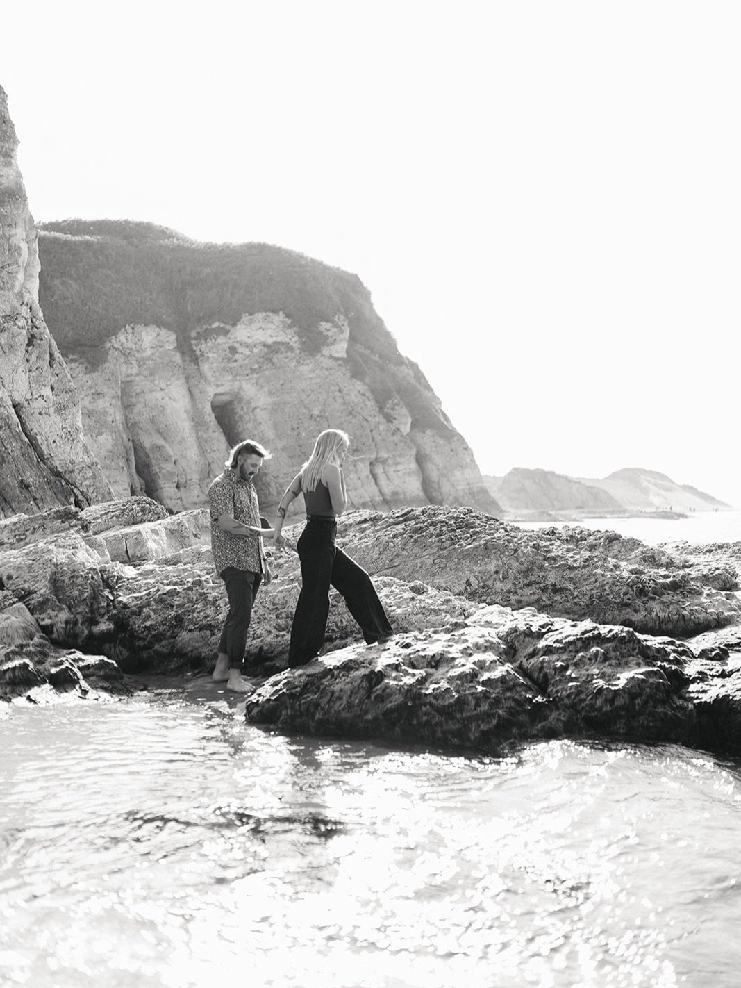 Junia &amp; Andy engaged in my forever favourite backdrop, Whiterocks beach 🤍 a moment in B&amp;W