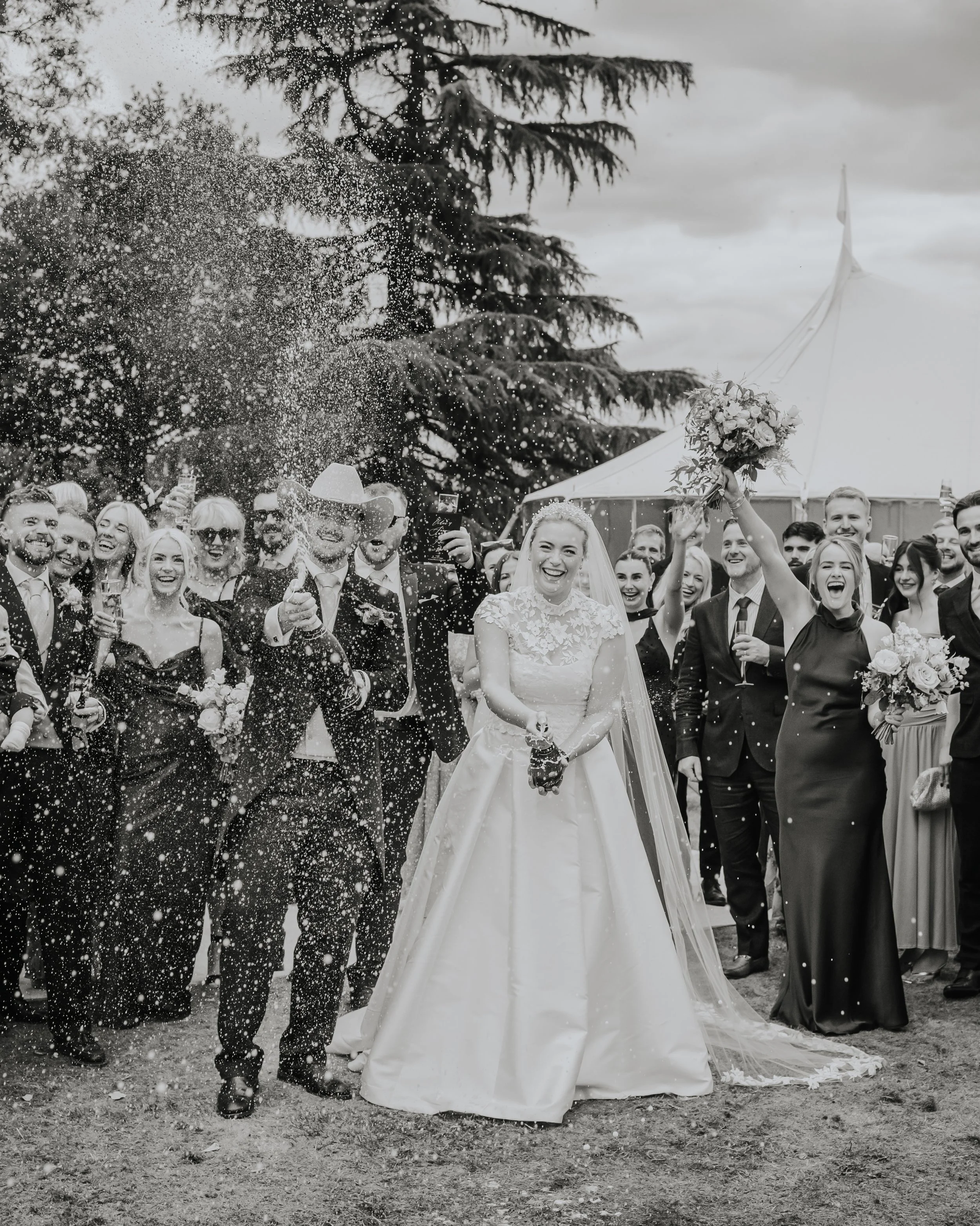 berkshire-wedding-photography-champagne-spray-couple-guests.jpg