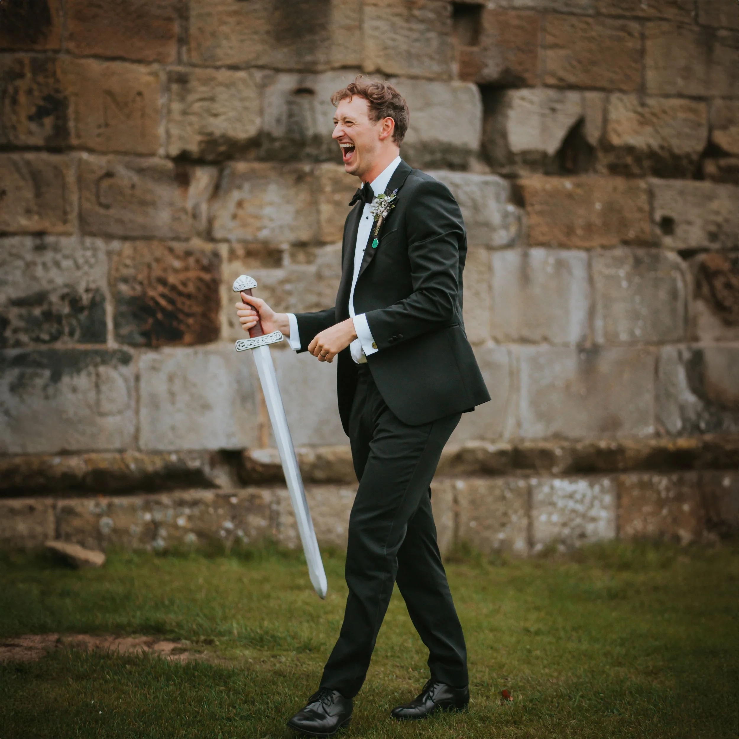 groom-danby-castle-barn-wedding-whitby-sword.jpg