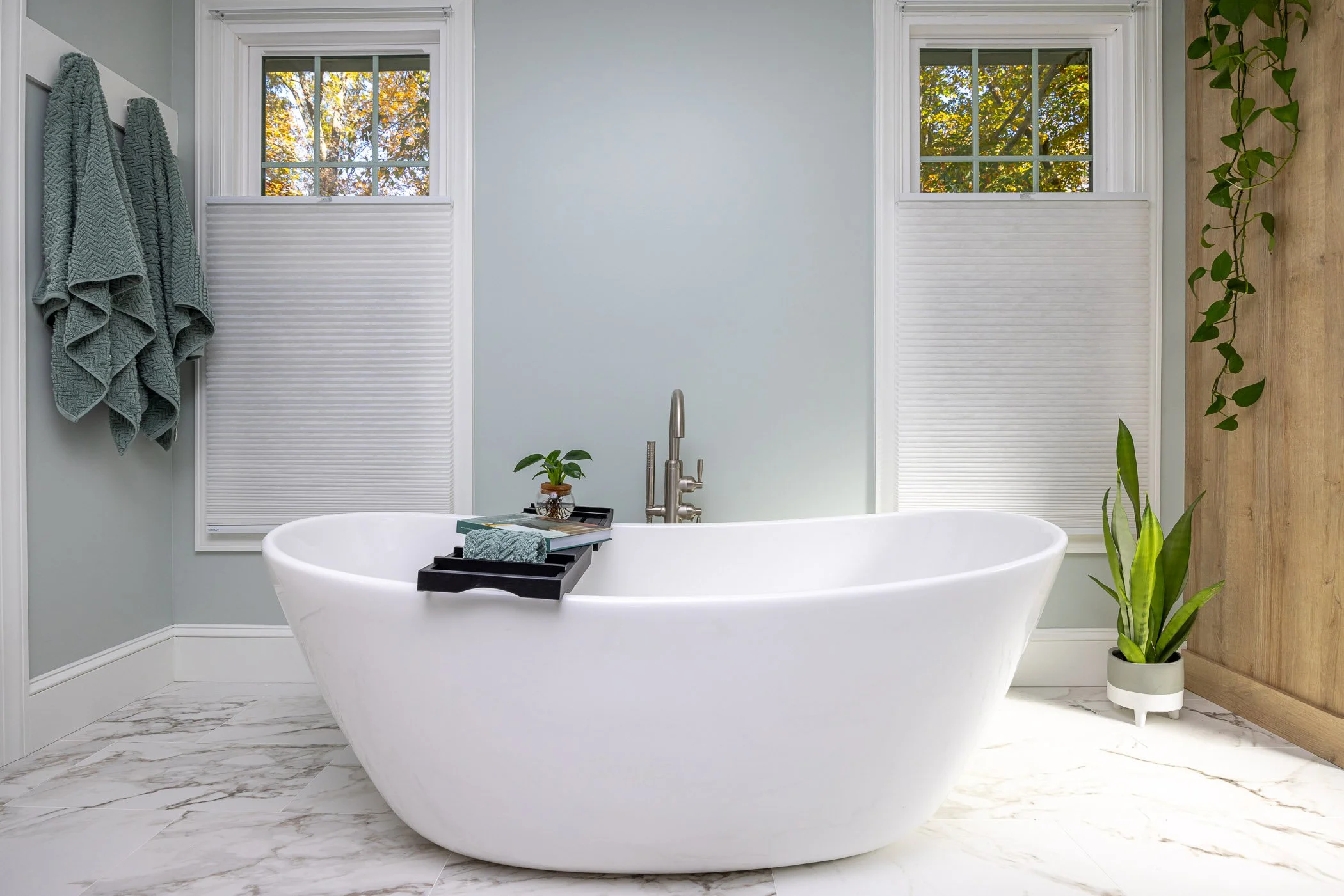 Modern freestanding tub in a newly renovated open and airy luxury bathroom.