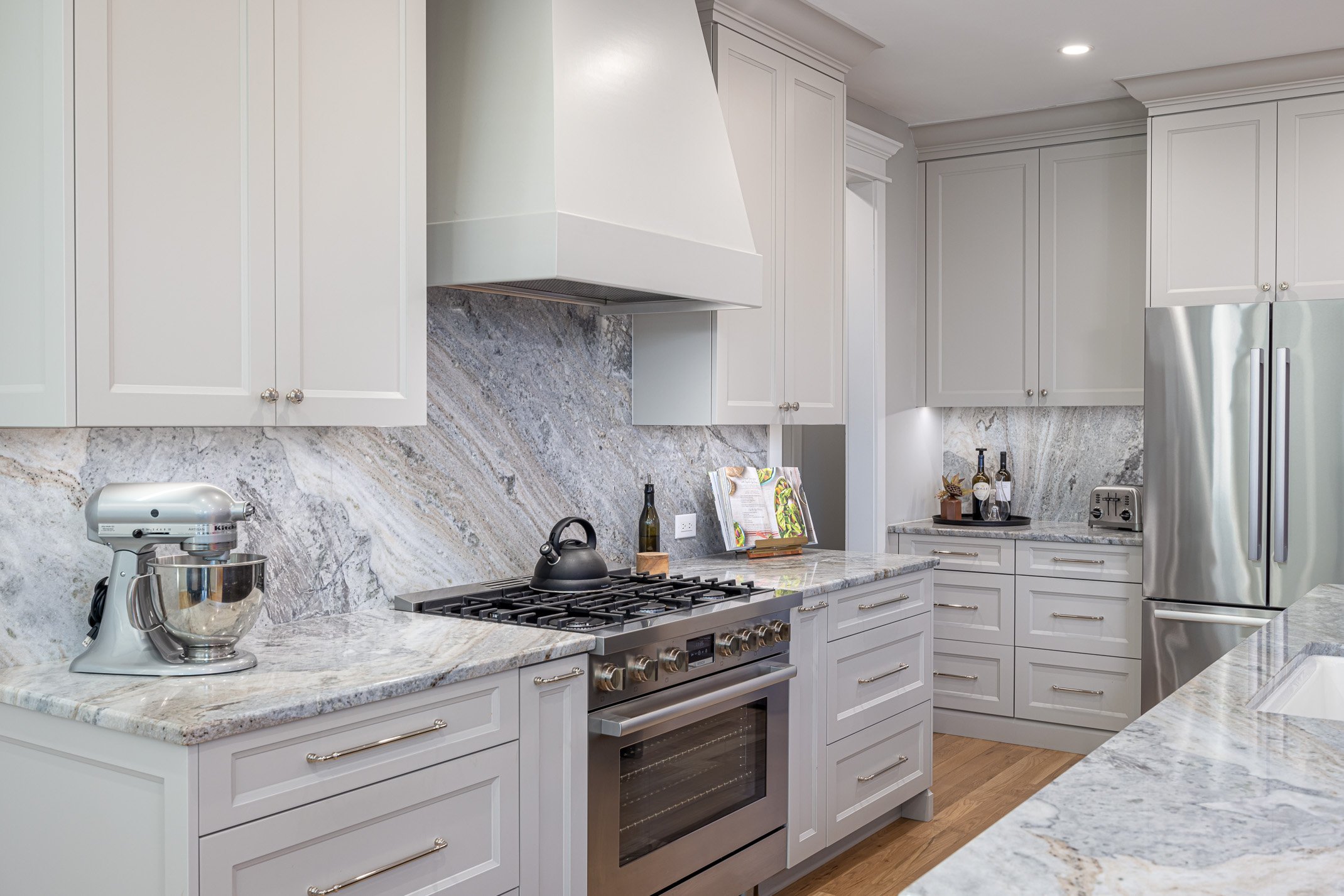 This modern kitchen is new construction. The perimeter cabinetry is by Cuisine Ideale custom color door Ogden (to match SW Repose Grey, Island brushed ashe). The door style is York, and the color is glazed hacienda.
Lovely Portinario marble continuo