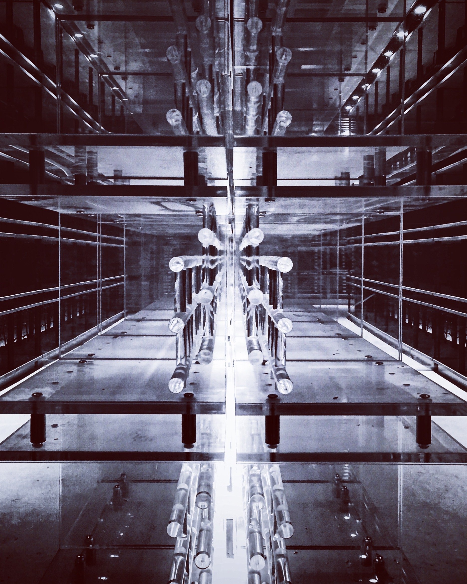 A mirrored and transparent display case with multiple LED light bulbs arranged symmetrically inside, creating a visually intriguing pattern.